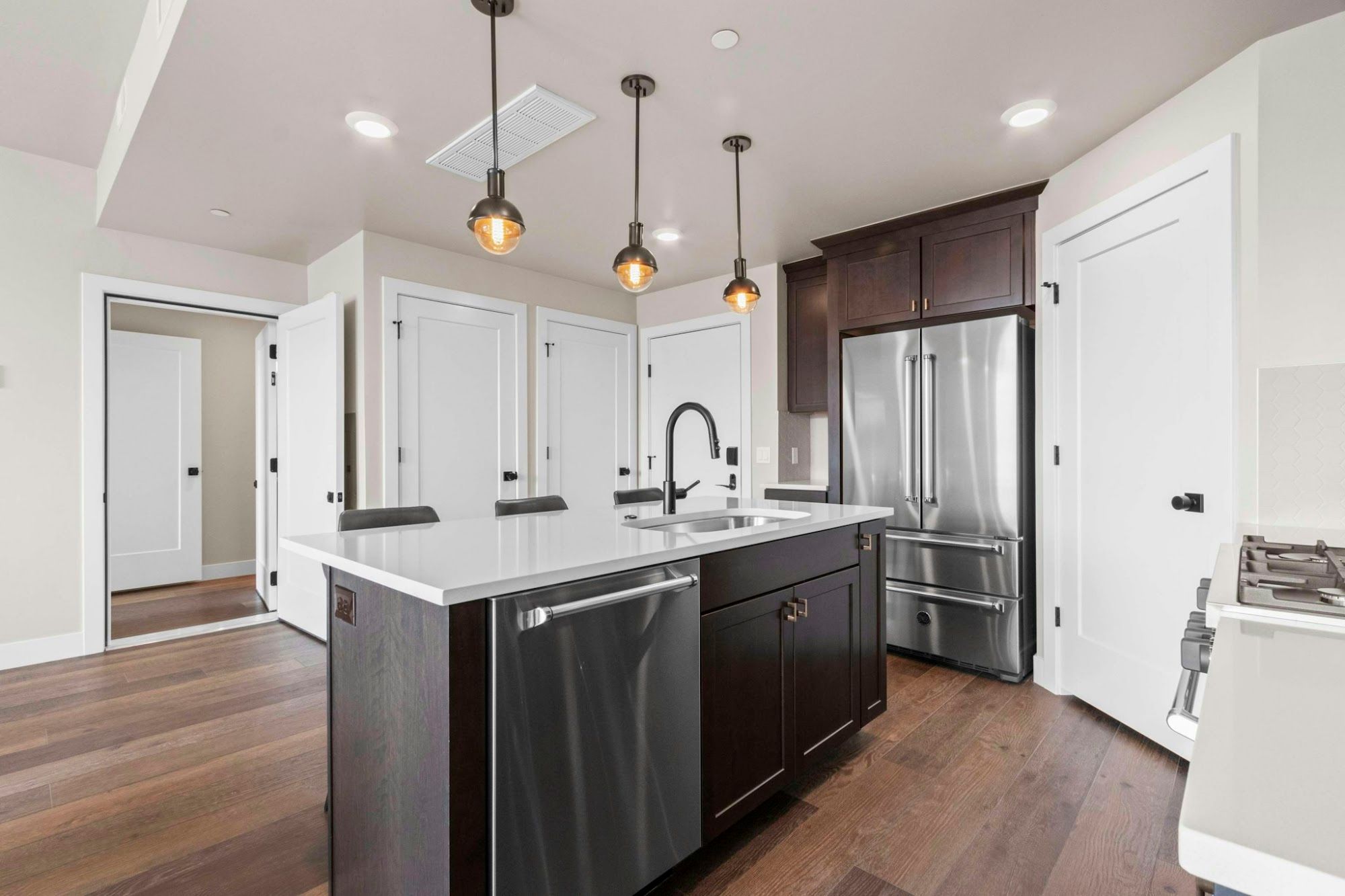 image Fully equipped kitchen with stainless appliances, island, and dishwasher