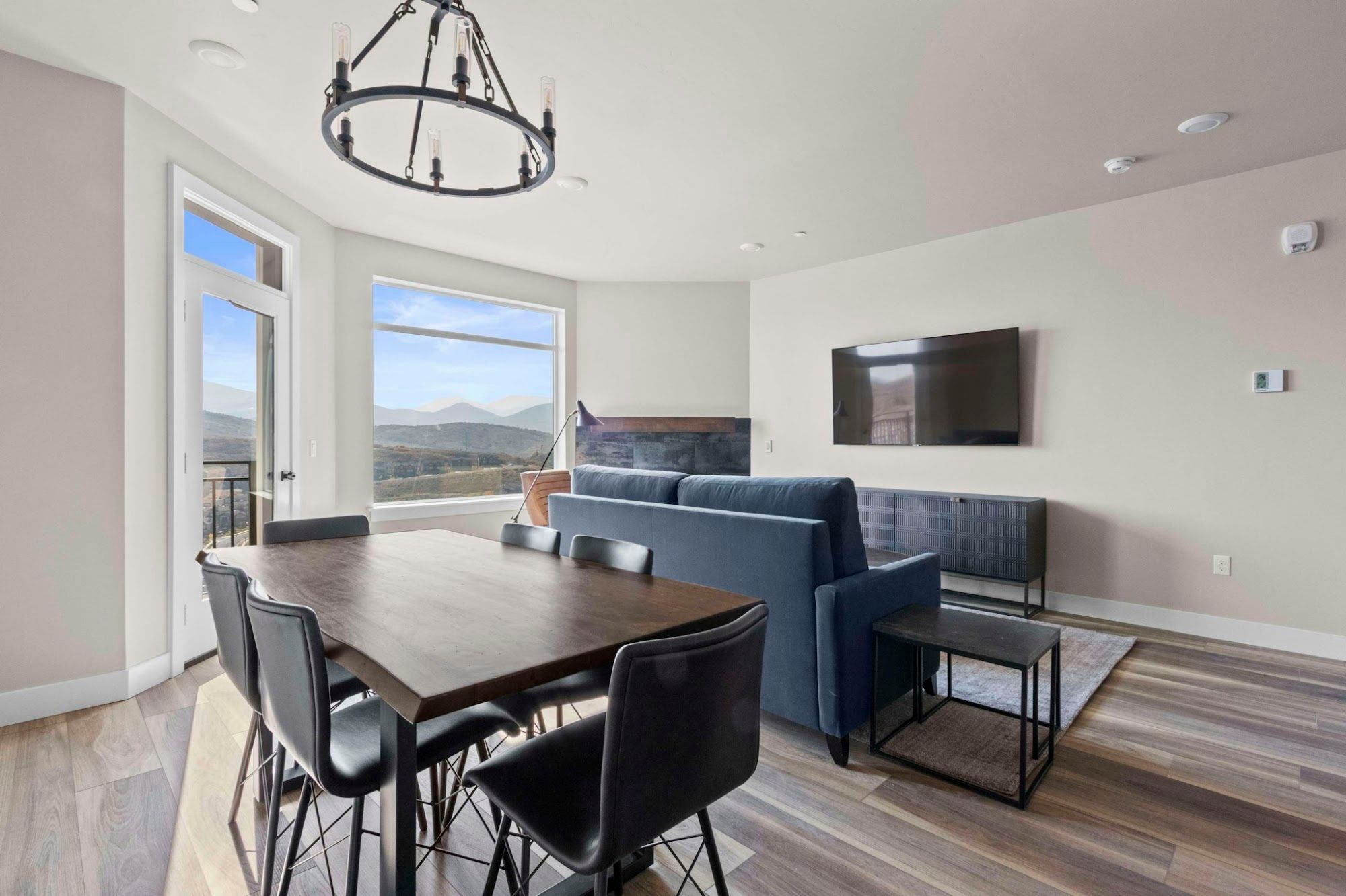image Dining area with sofa and large windows overlooking the mountains