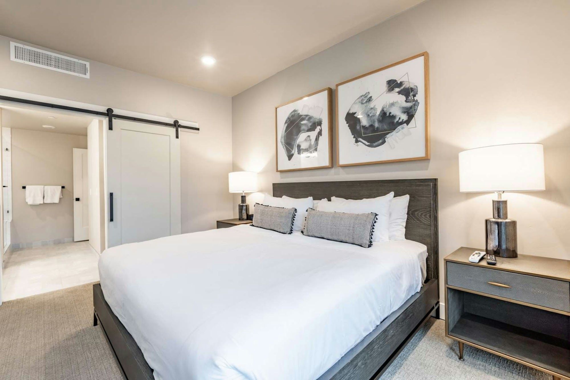 image Bedroom with king-size bed, upholstered headboard, and wall art