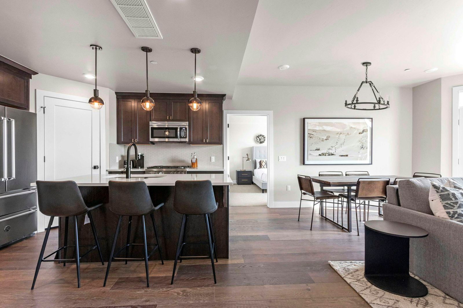 image Open kitchen with island seating, dining area, and mountain-view living space