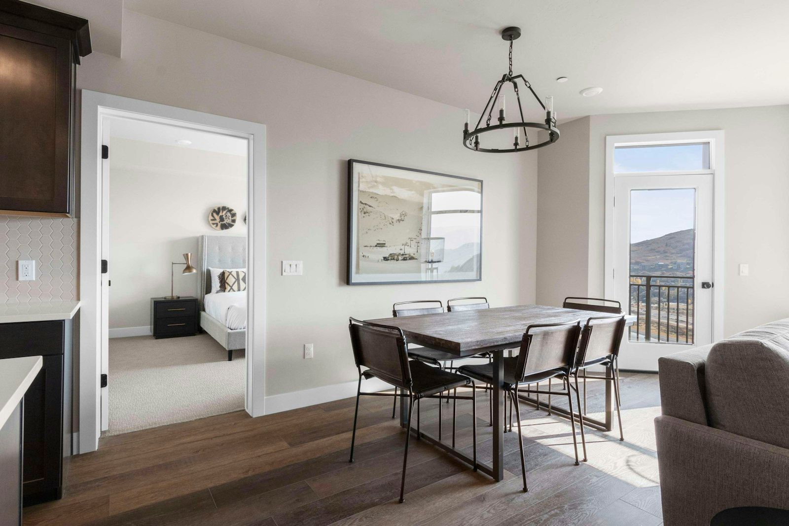 image Dining table and chandelier with balcony door and mountain view