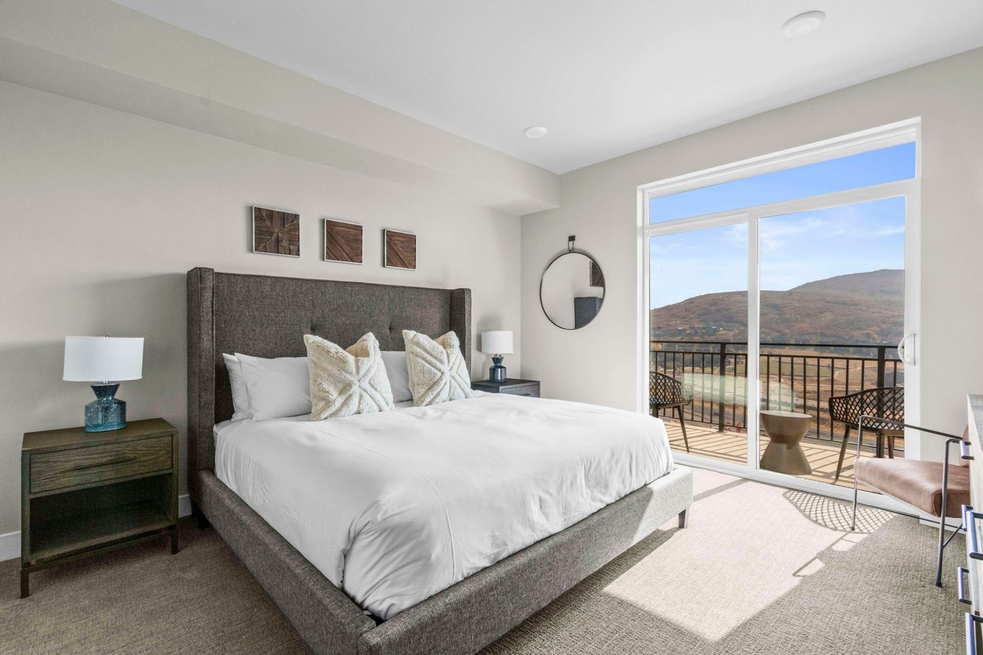 image King master bedroom with upholstered headboard, balcony access, and mountain views