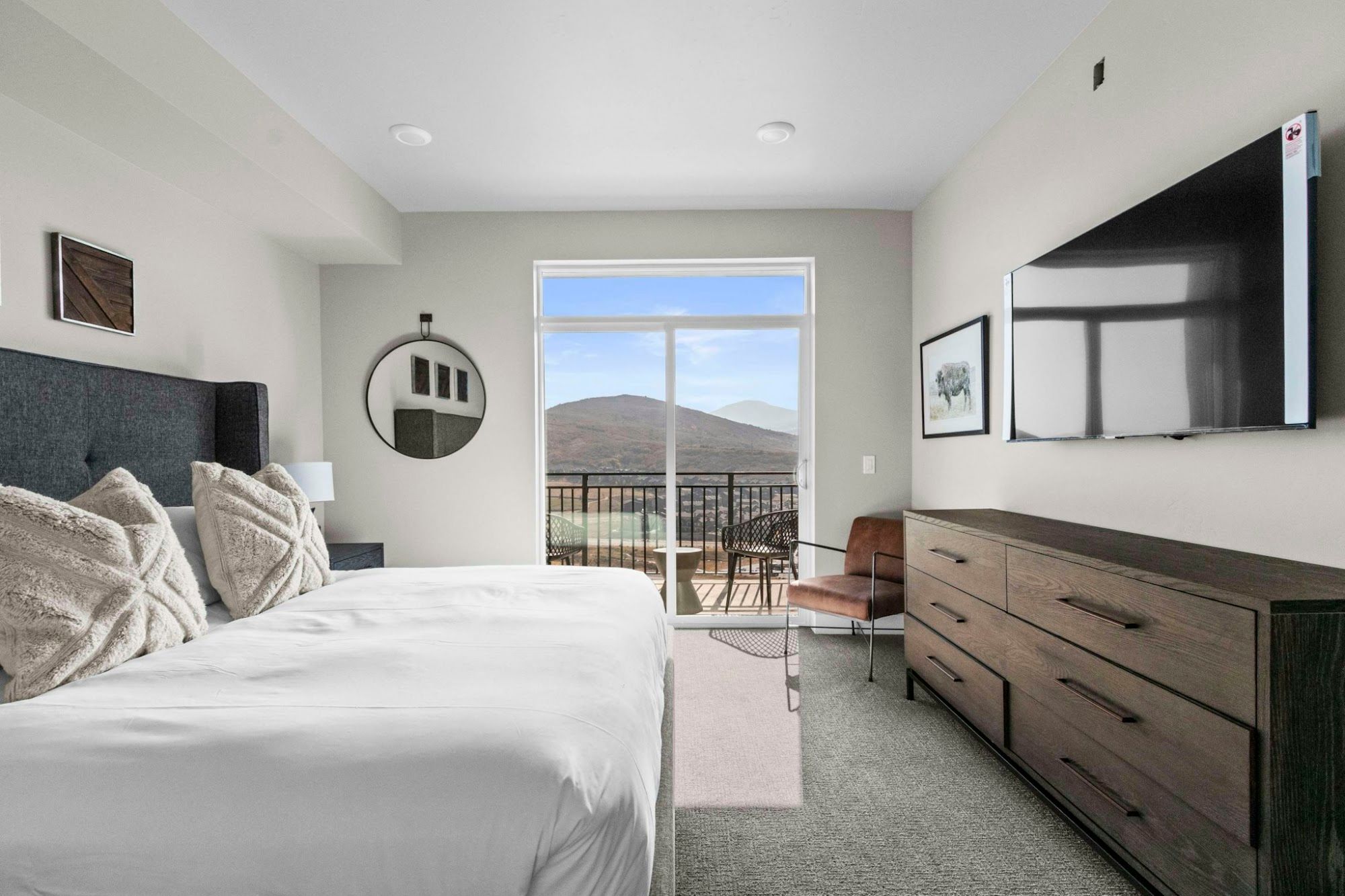 image Bedroom with king bed, wall art, TV, and seating area