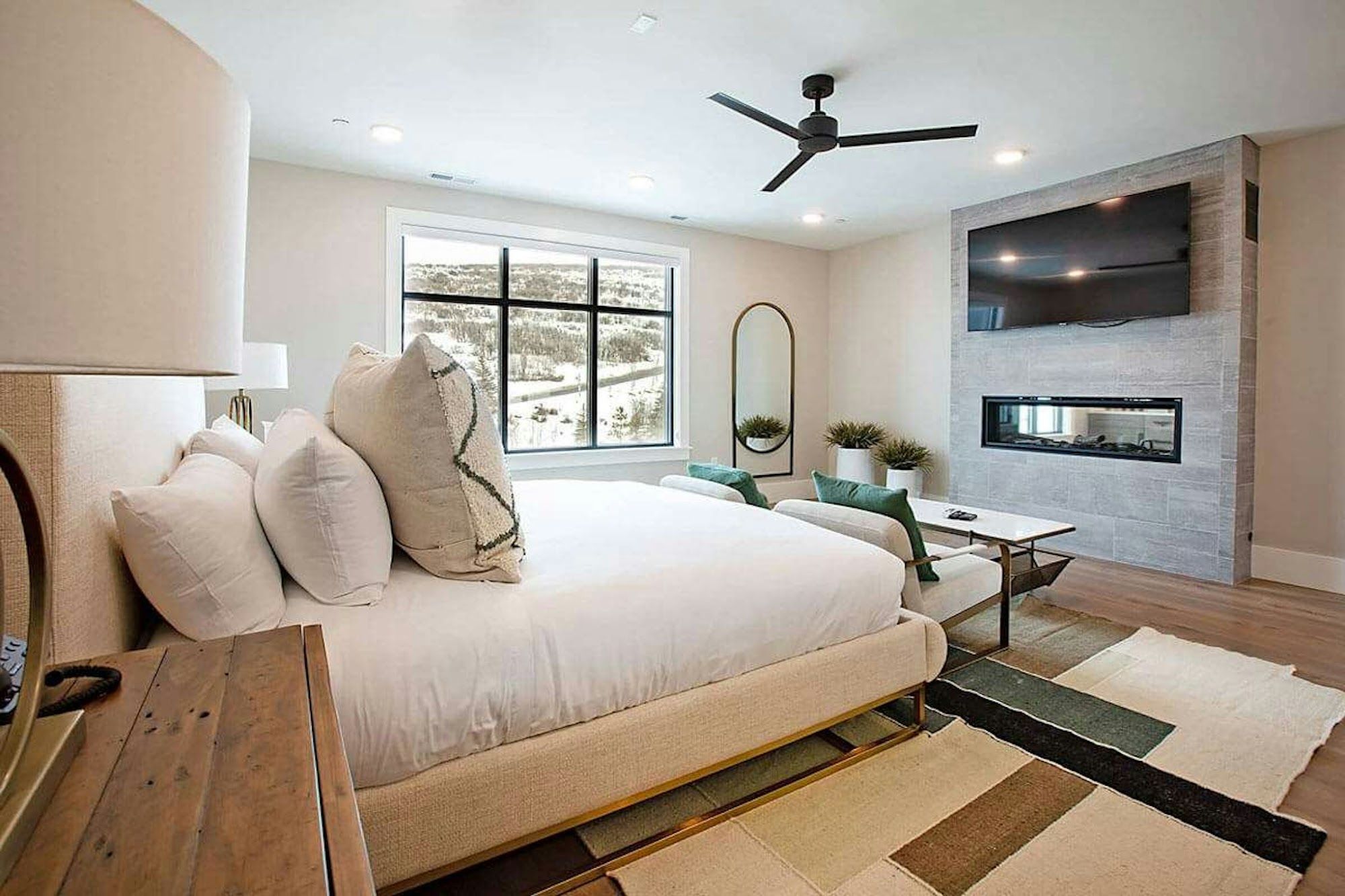 image King bedroom with fireplace and mountain views