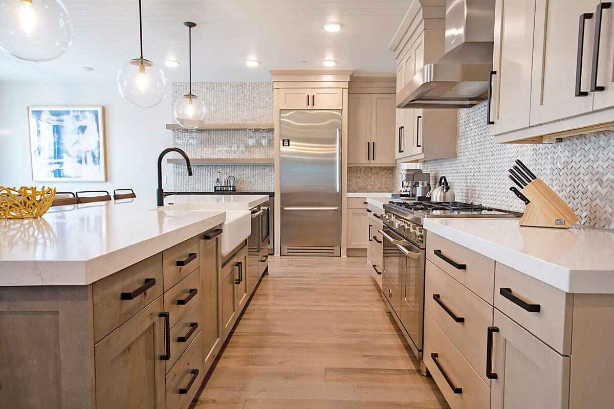 image Kitchen with cabinets, countertops, a refrigerator, a stove, and pendant lighting