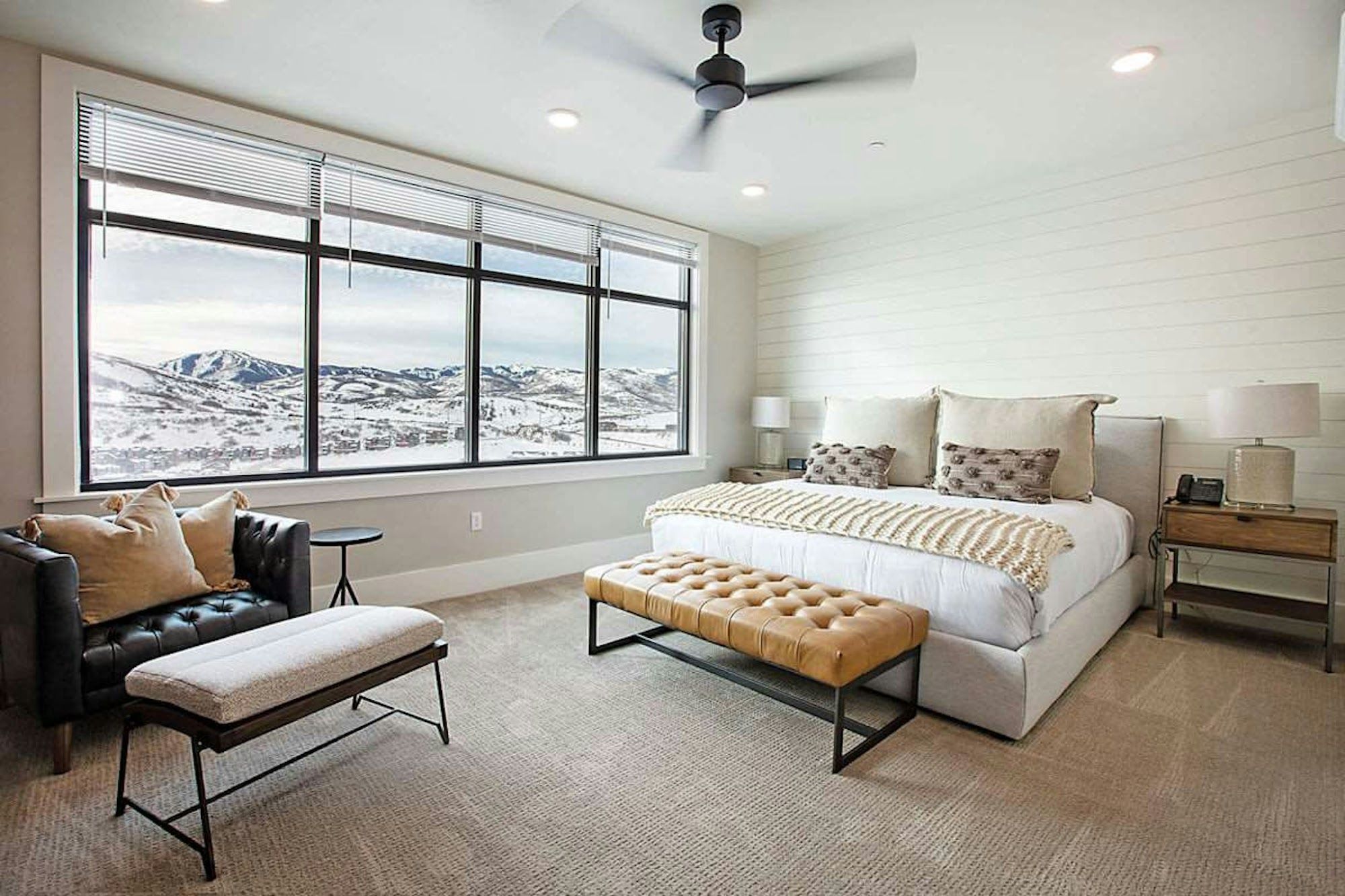 image King bedroom with panoramic snowy mountain views through large picture windows