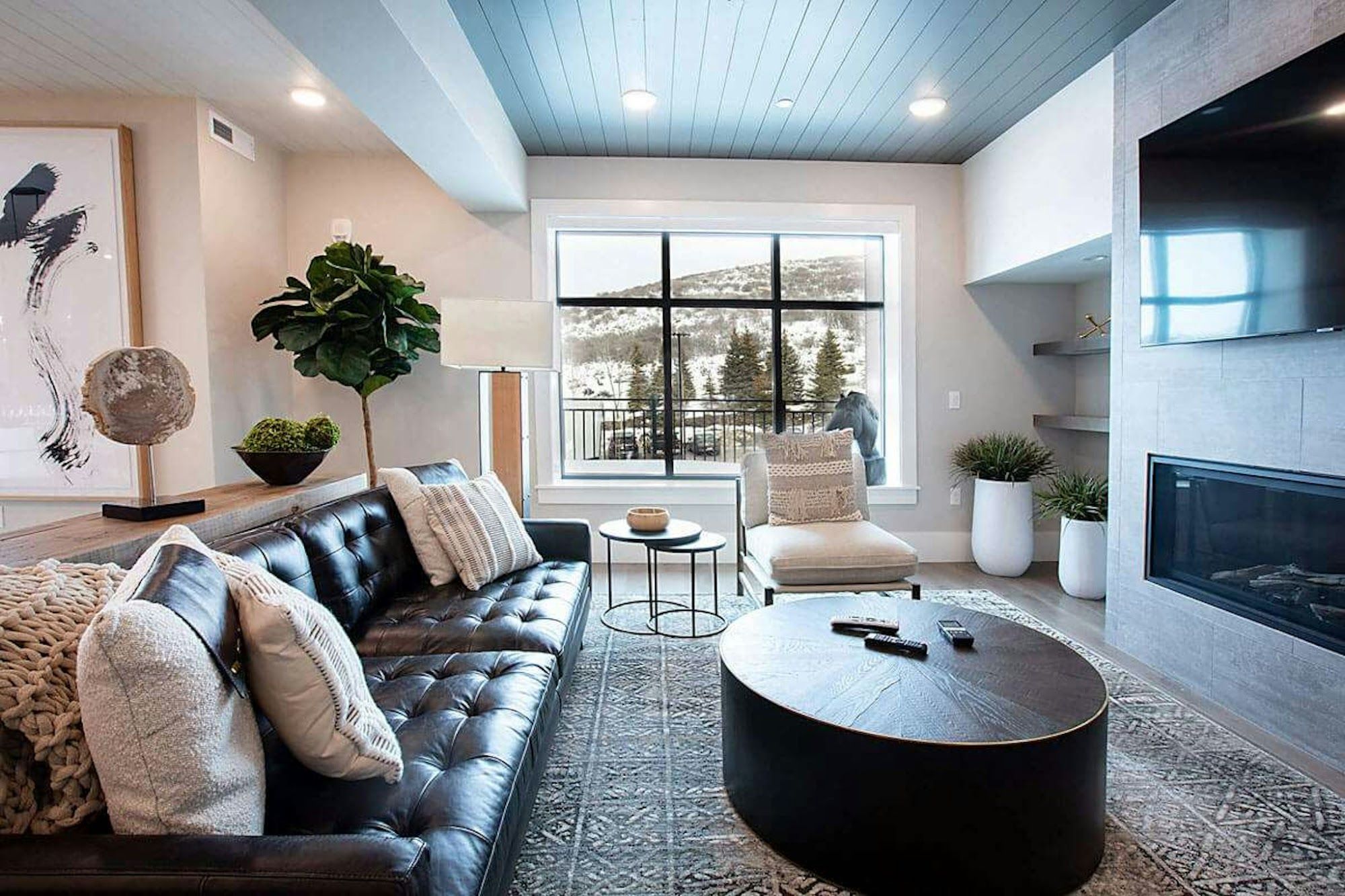 image Living area with leather sofa, linear gas fireplace, and mountain views