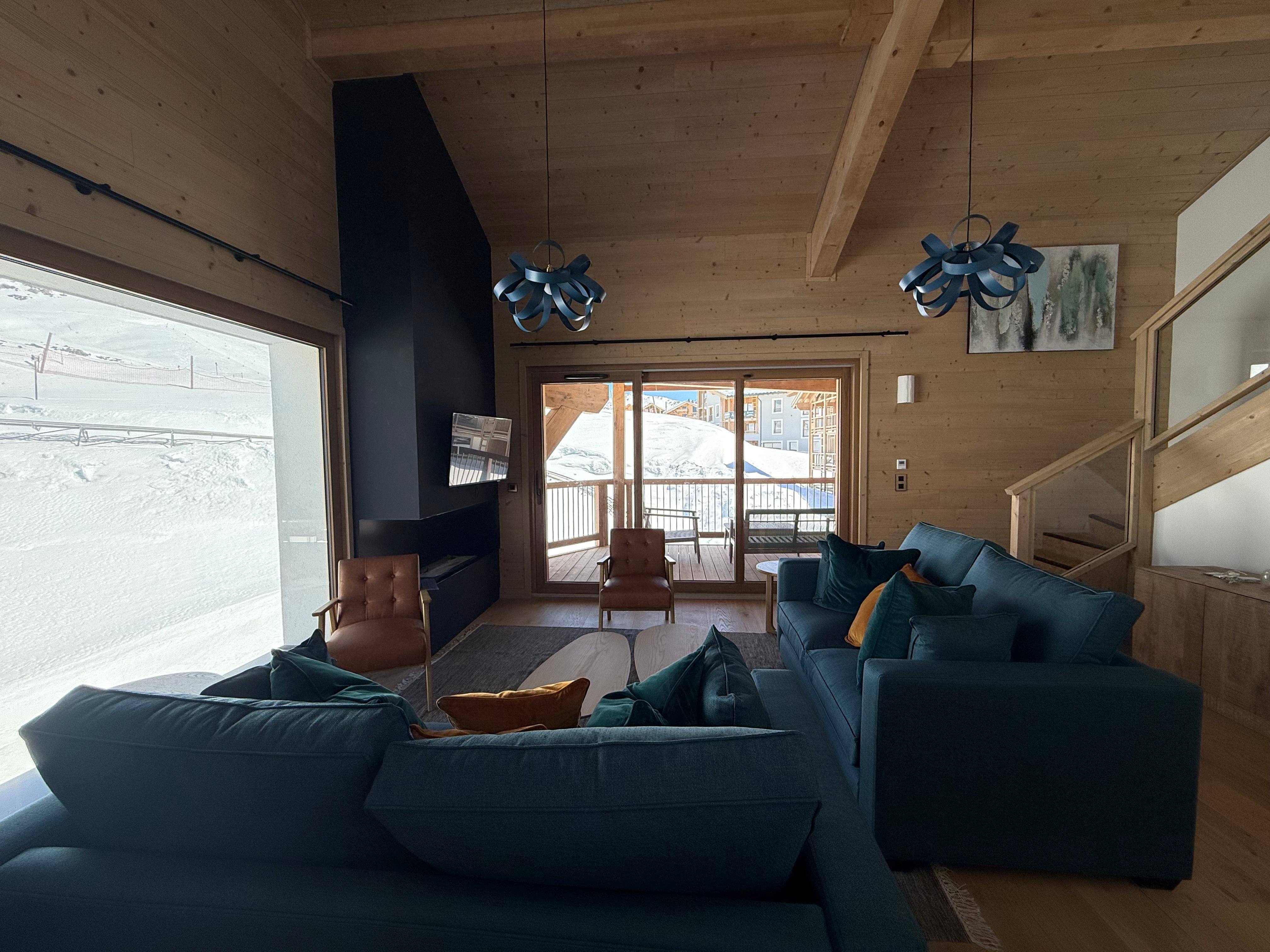 image Ski straight back to the apartment, then unwind beneath the vaulted timber ceiling in this cosy living room.