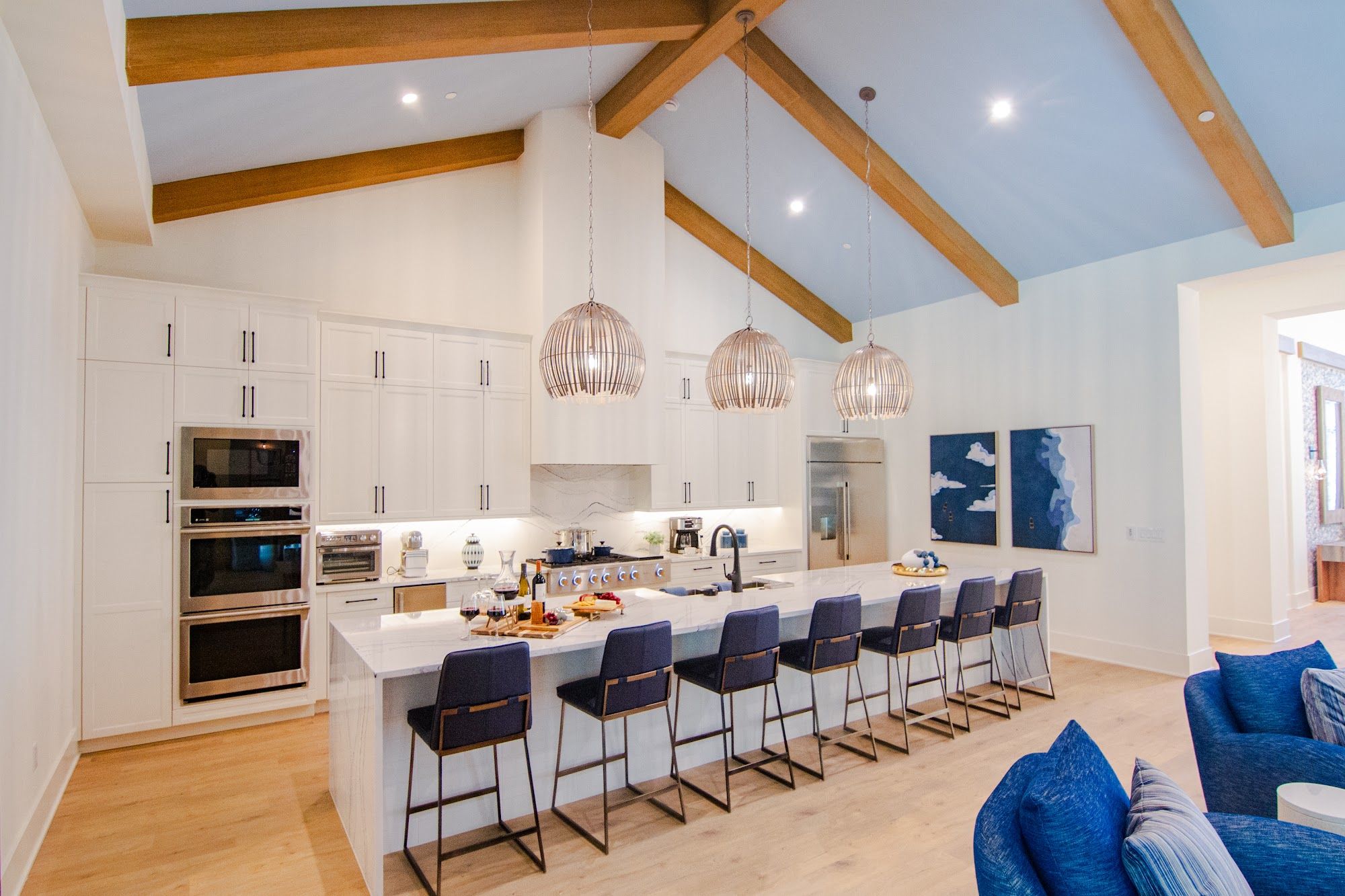 image Chef-style kitchen with island seating and premium stainless appliances