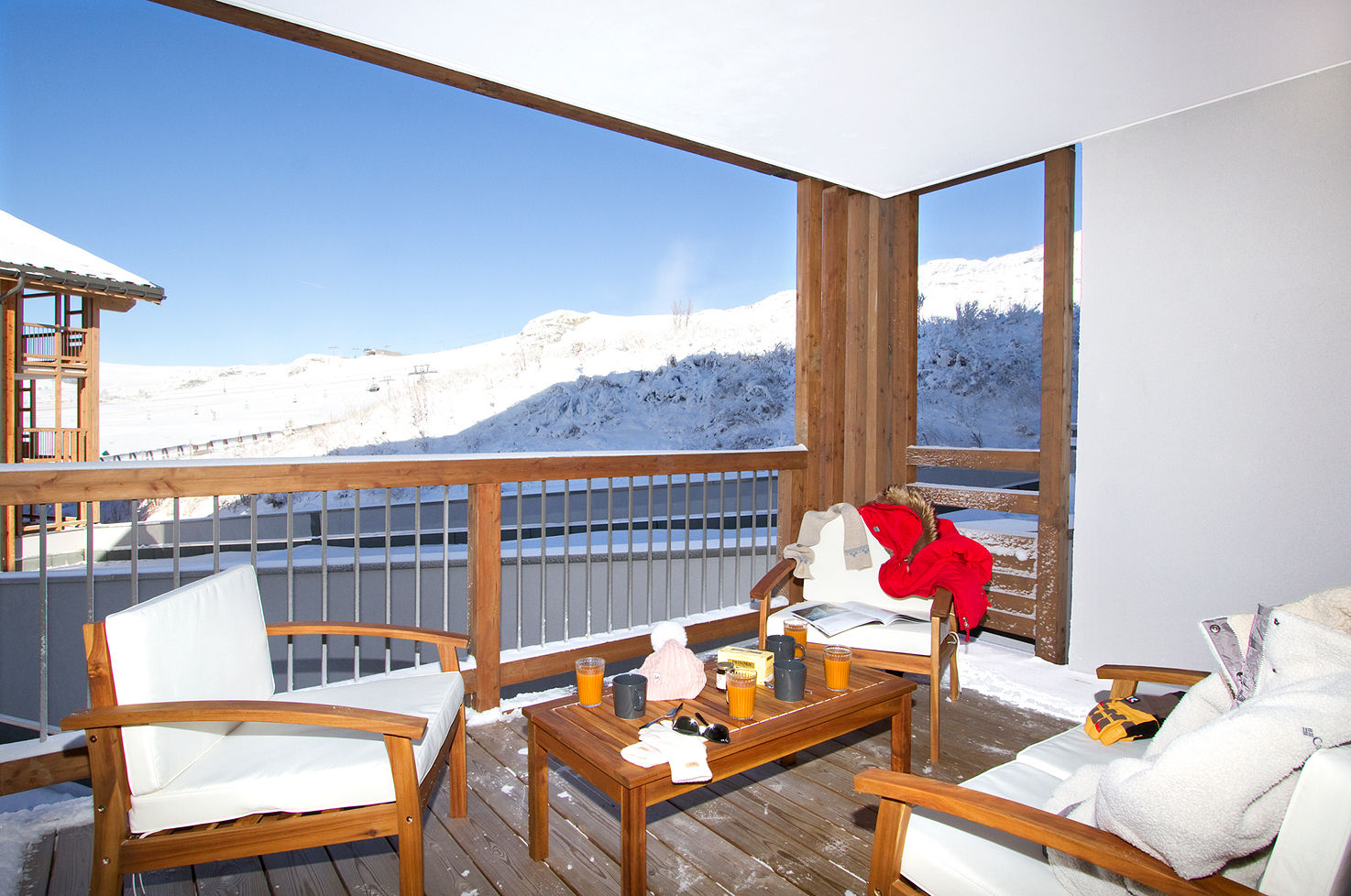 image East-facing terrace catches the morning sun over the Alpe d'Huez peaks, with room for coffee.