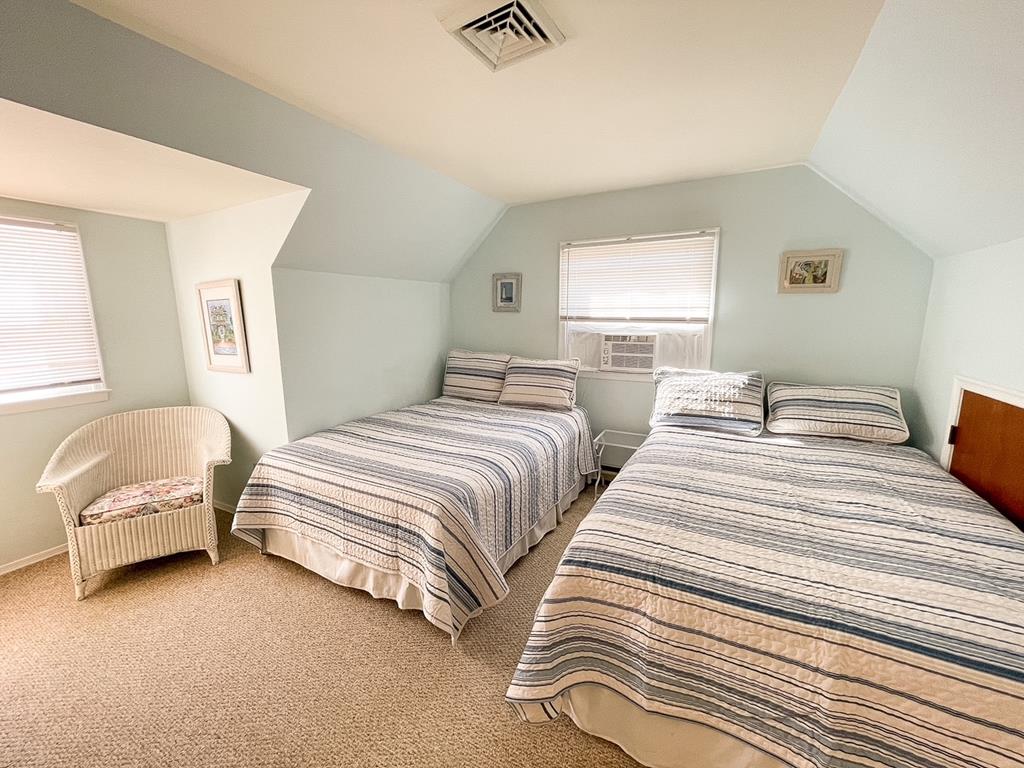 image Cozy bedroom featuring two comfortable beds