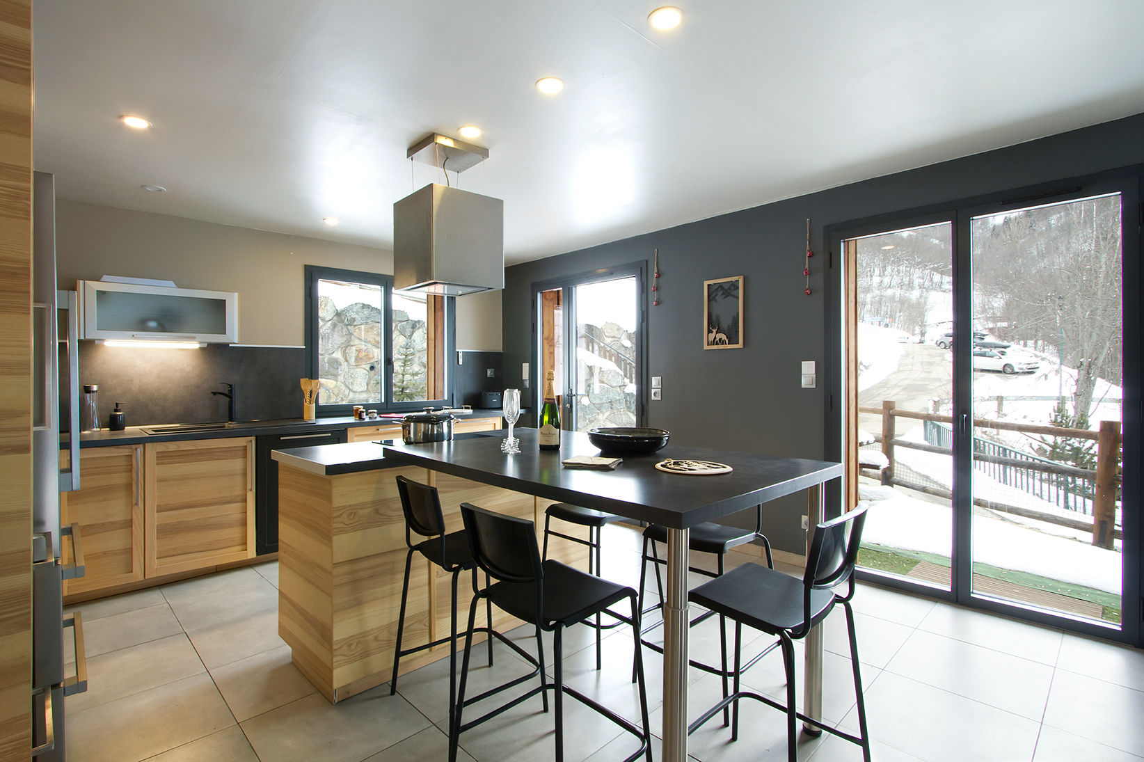 image Modern kitchen with dark accent wall and counter seating