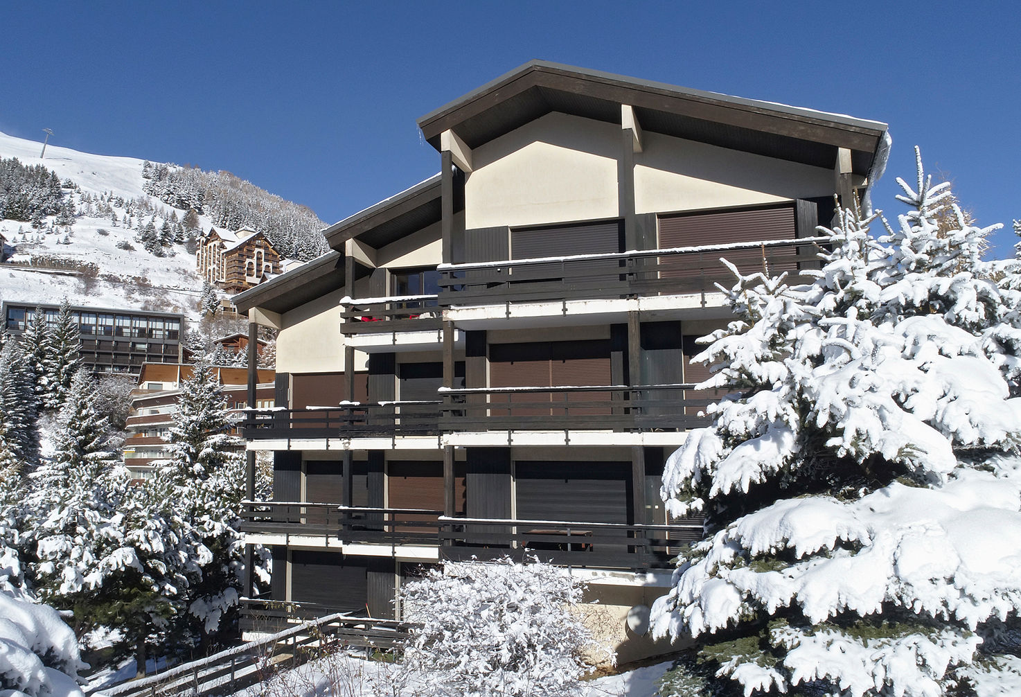 image Alpine chalet blanketed in fresh snow beneath towering pines