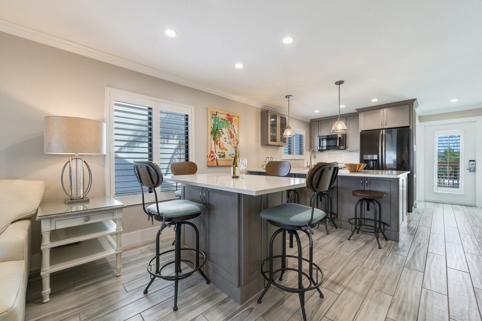 image The modern kitchen boasts sleek cabinetry and stylish bar seating, perfect for casual dining or entertaining.