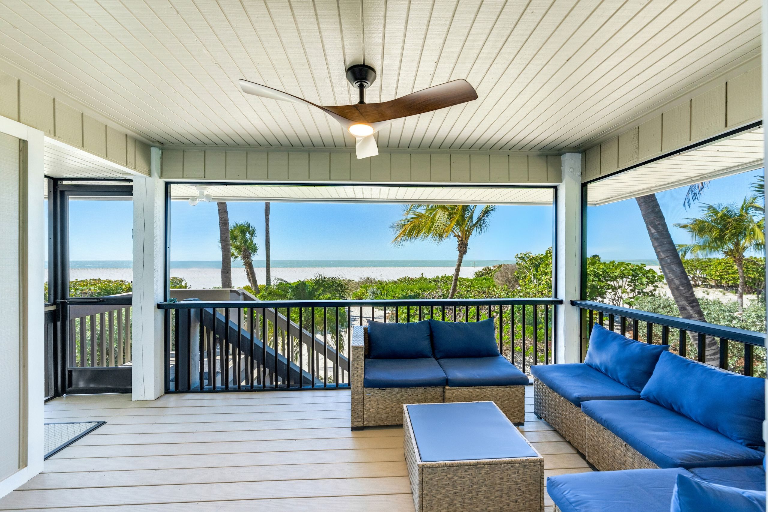 image A cozy screened-in lanai offers tranquil water views, perfect for relaxing in gentle breezes.