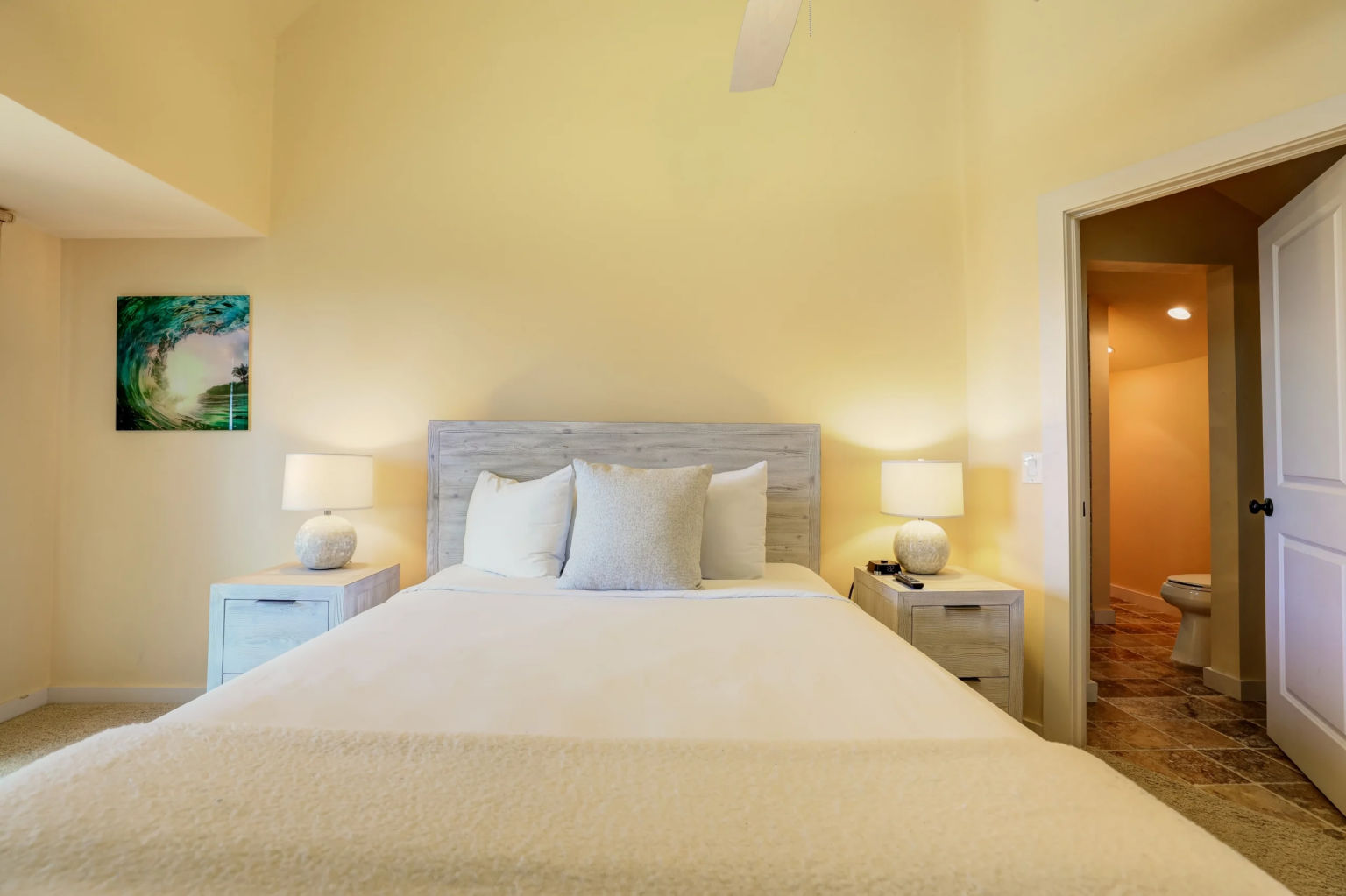 image The serene bedroom boasts a soft color palette and tranquil lighting, providing a restful retreat after a day at the beach.