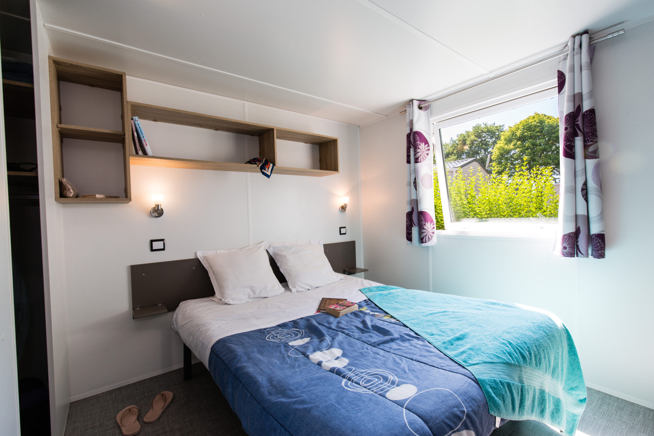 image The double bedroom, with natural light and floral curtains.