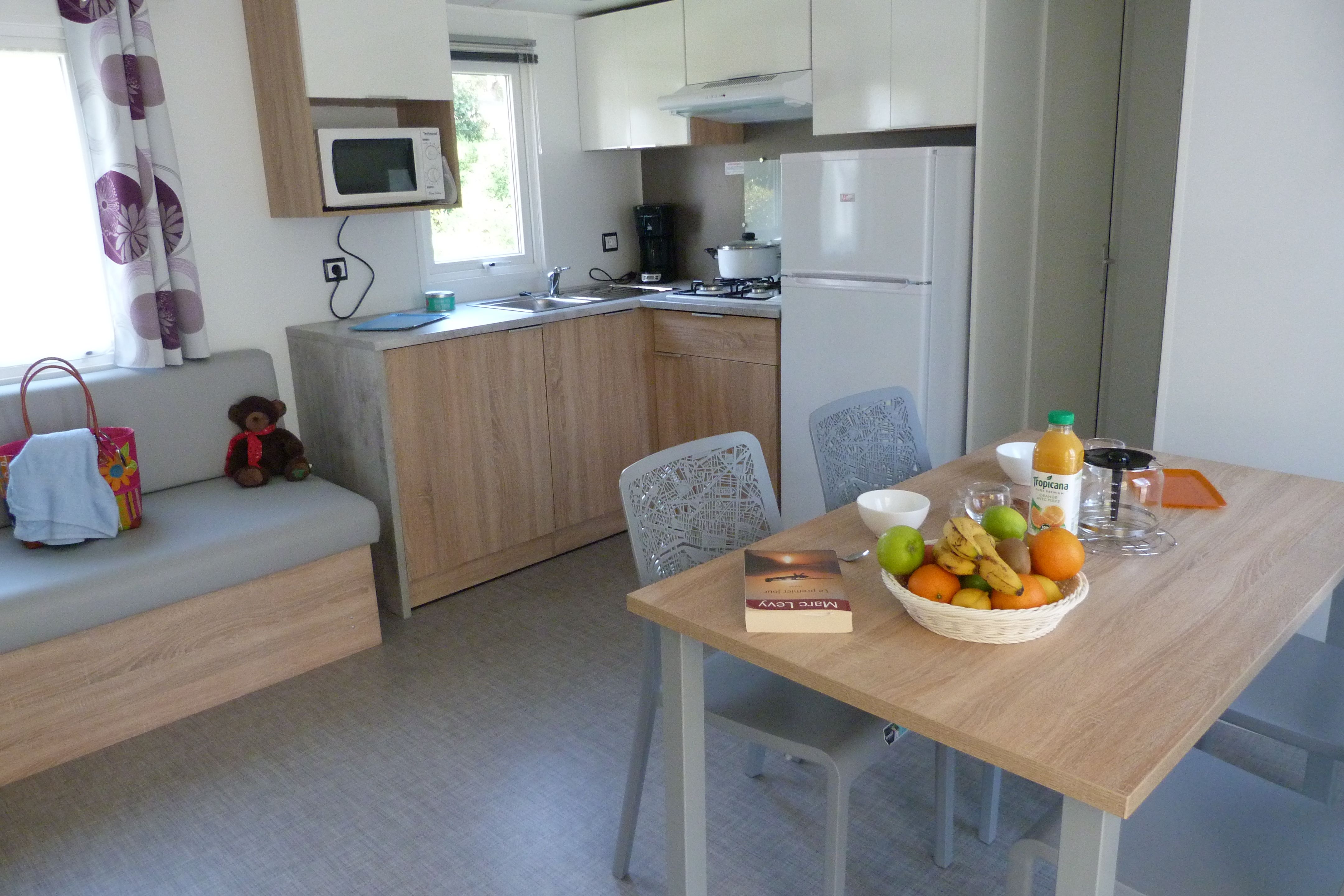 image The dining and kitchen area, bright and inviting.