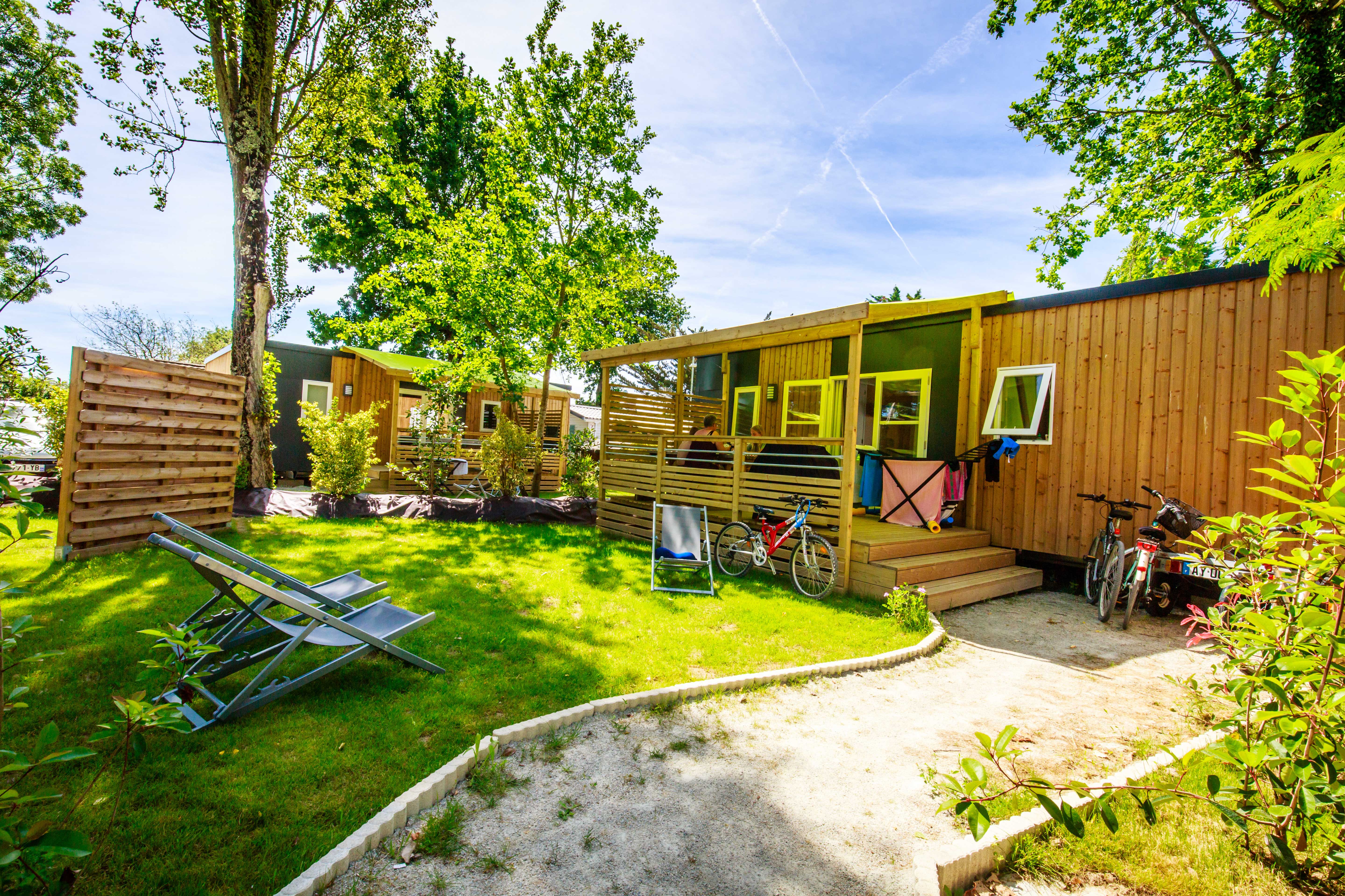 image The mobile homes set among trees and greenery.
