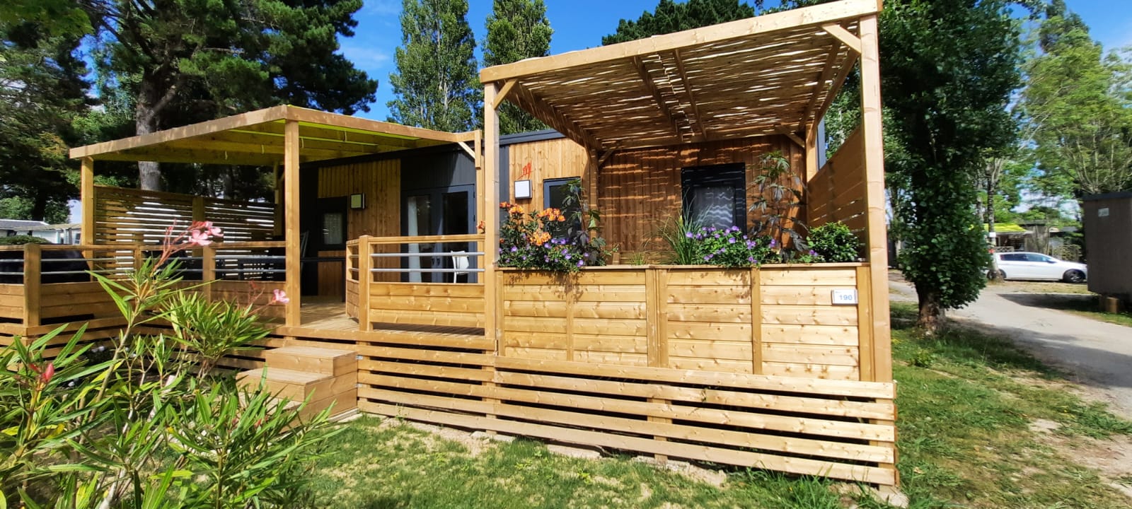 image The exterior of the mobile home, with its spacious shaded deck.