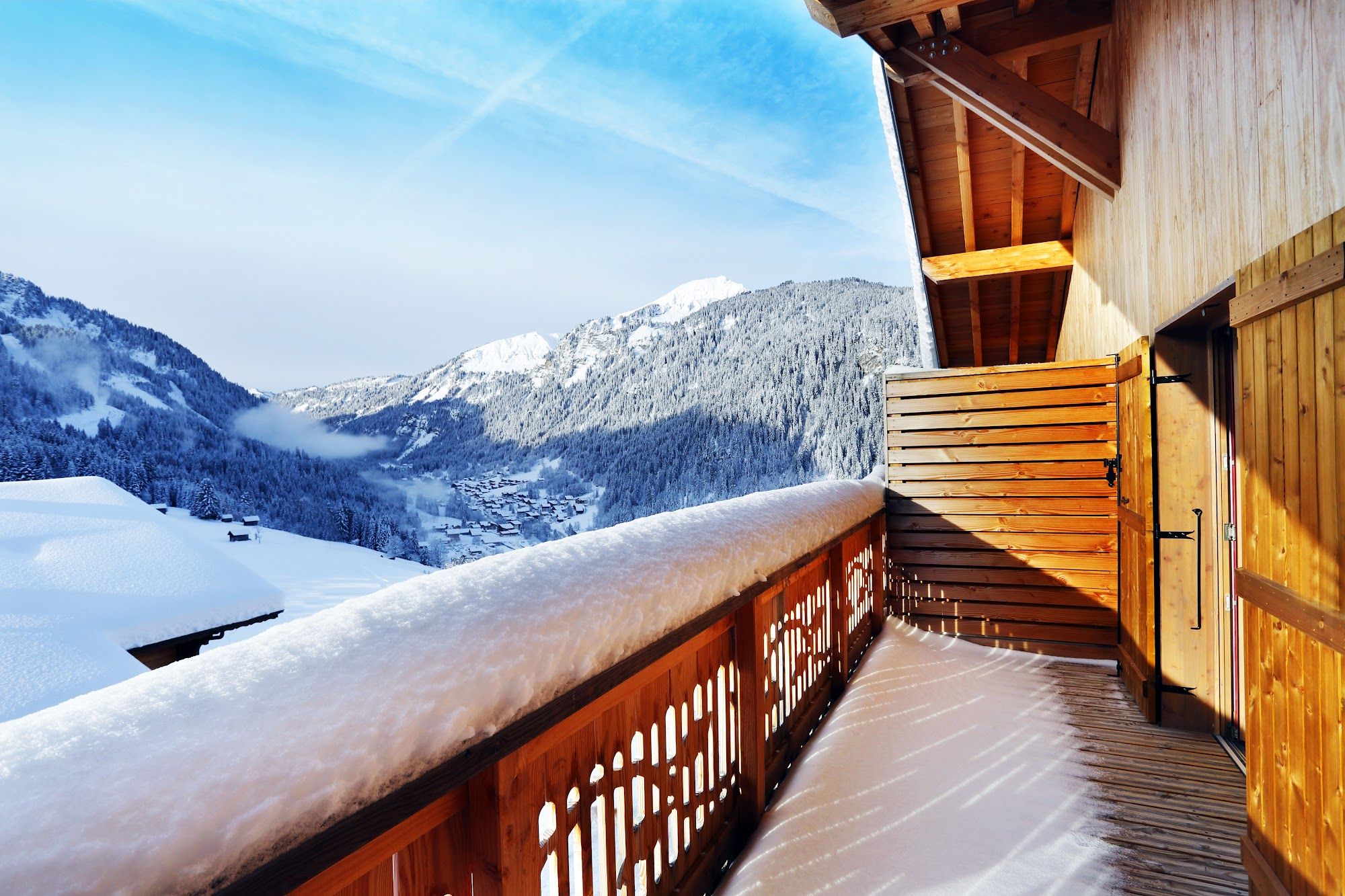 image Snow-covered balcony with wooden railings and mountain view