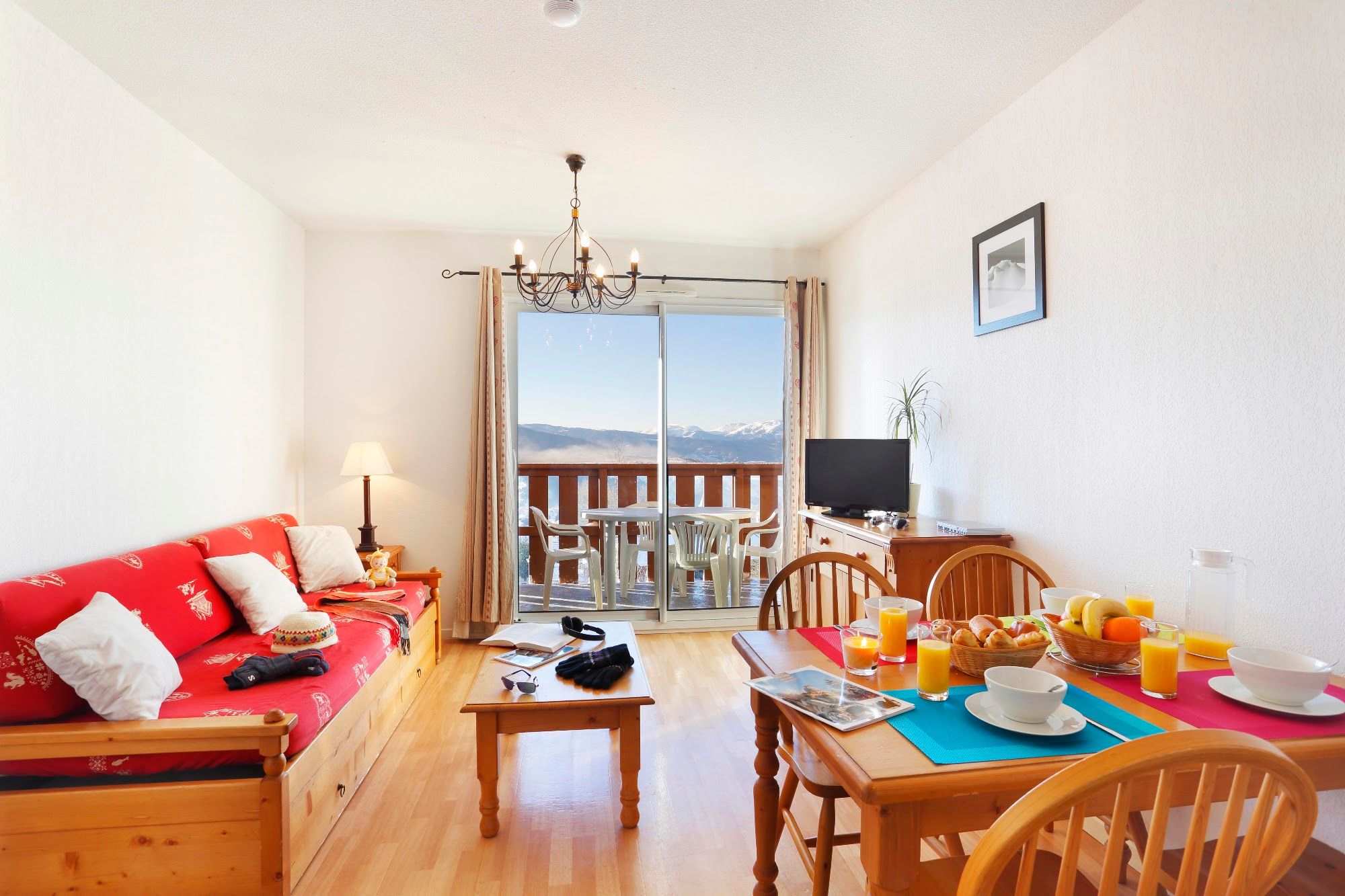 image Living and dining room with sofa bed, television and balcony access