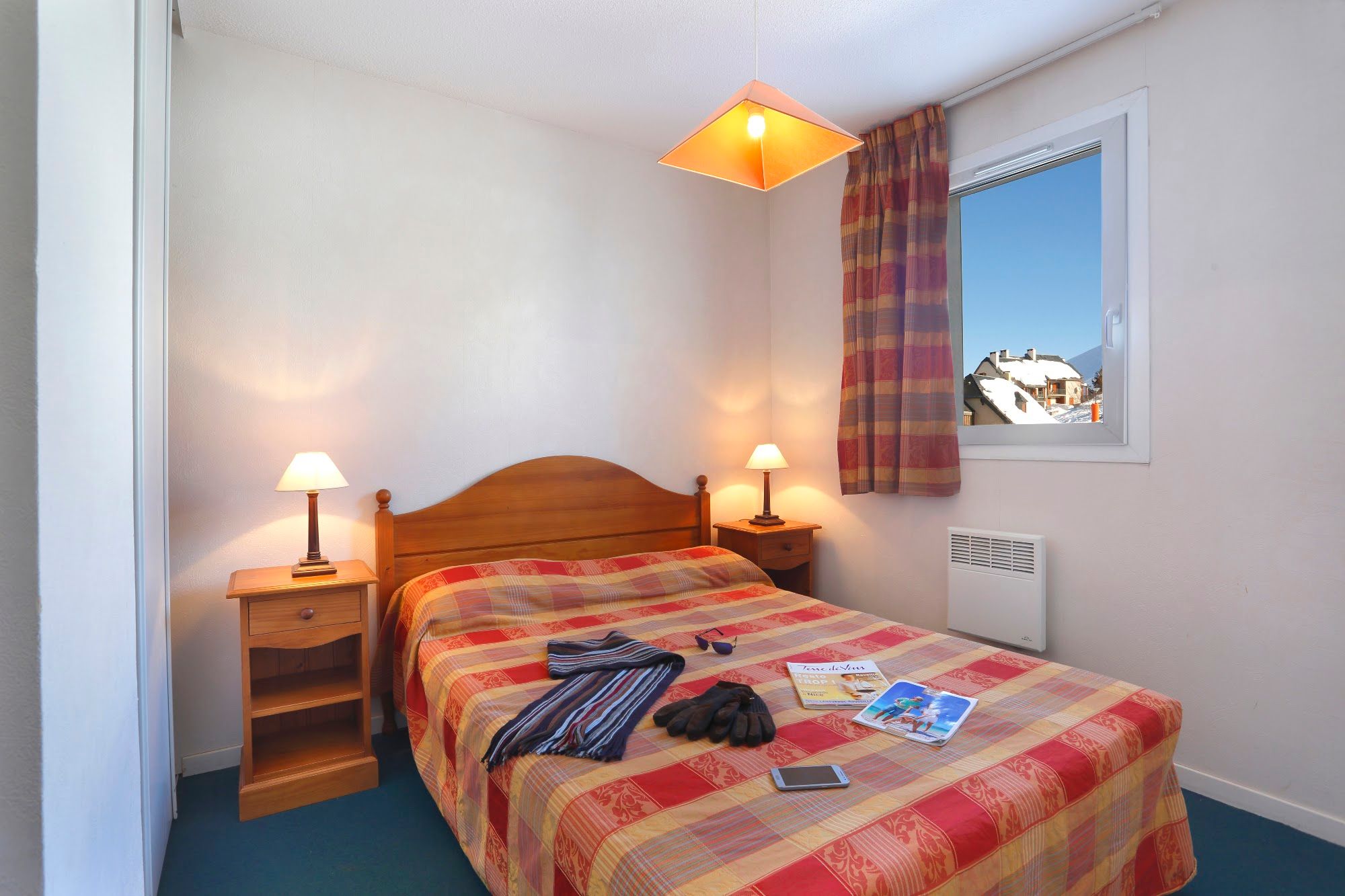 image Bedroom with a double bed, matching bedside lamps and a mountain-facing window