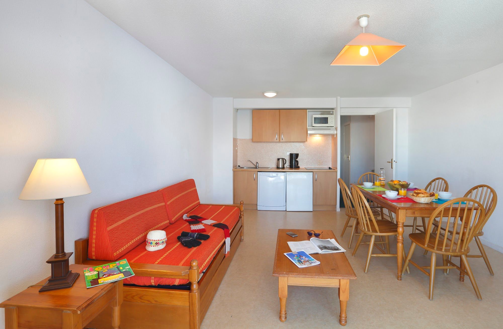 image Living and dining space with the kitchenette along the rear wall