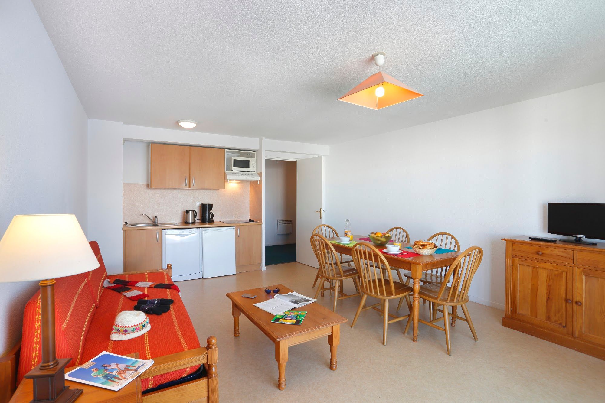 image Living and dining area with kitchenette, dining table and a flat-screen television