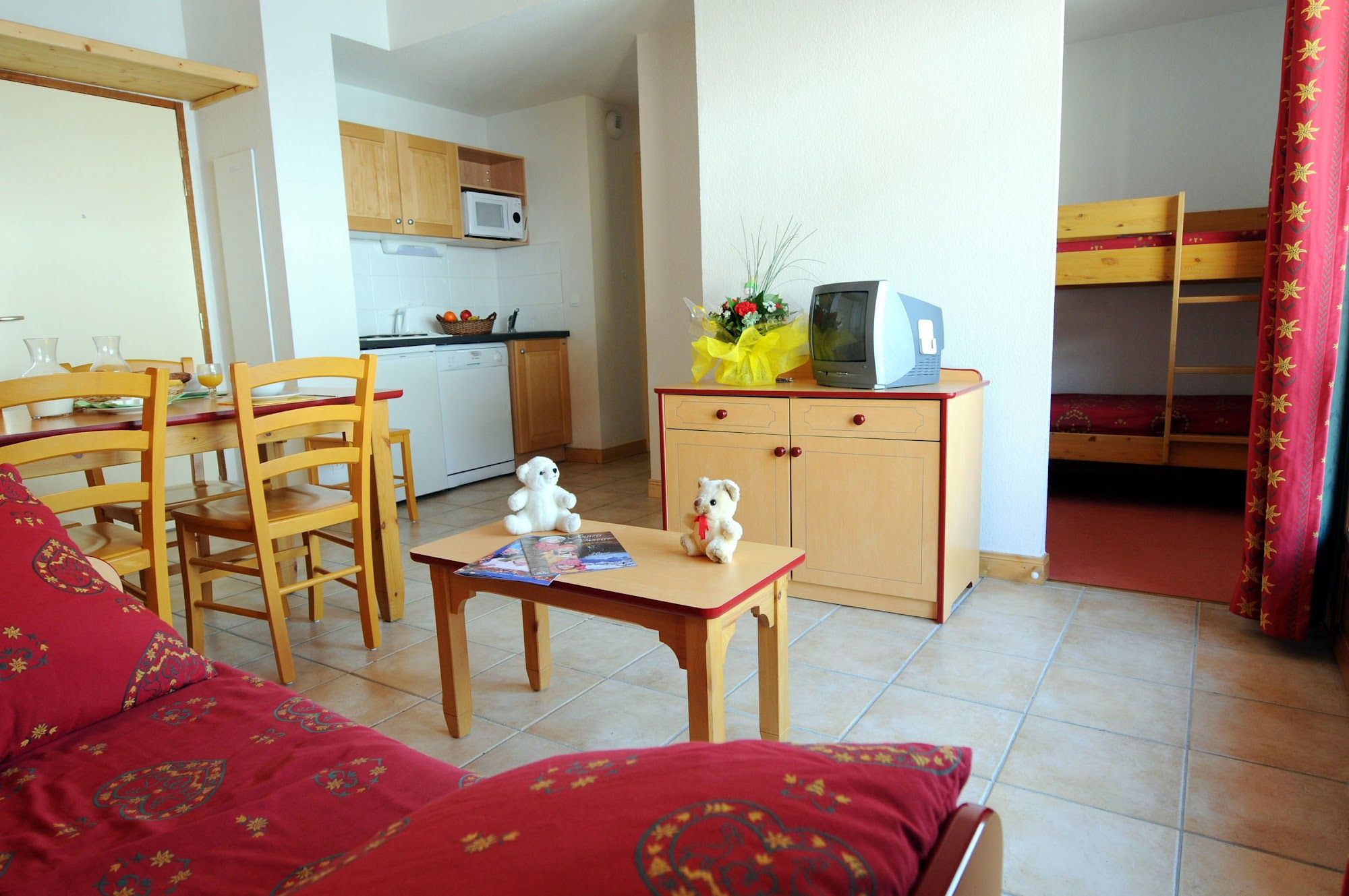 image Living area with kitchenette, dining table, sofa bed and bunk beds in the cabin alcove