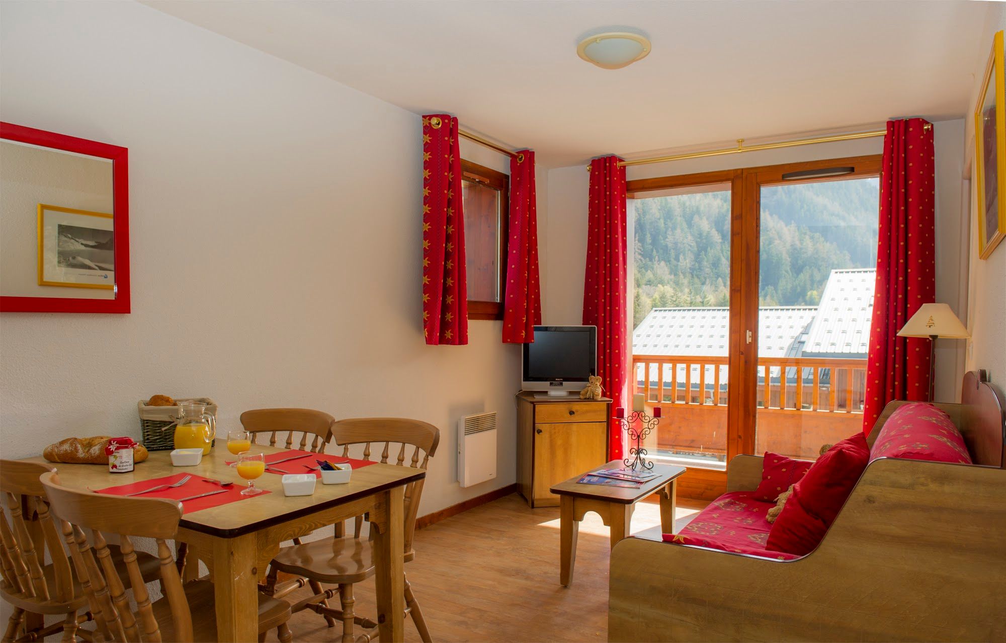 image Living and dining room with a laid table for six and a panel heater.