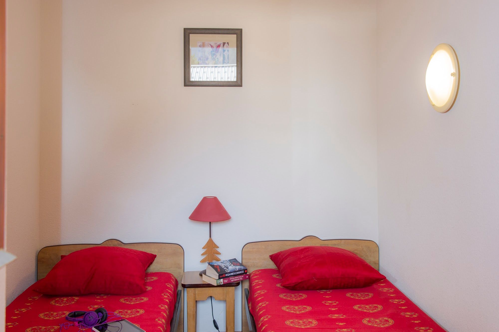 image Twin bedroom with two single beds either side of a bedside lamp.