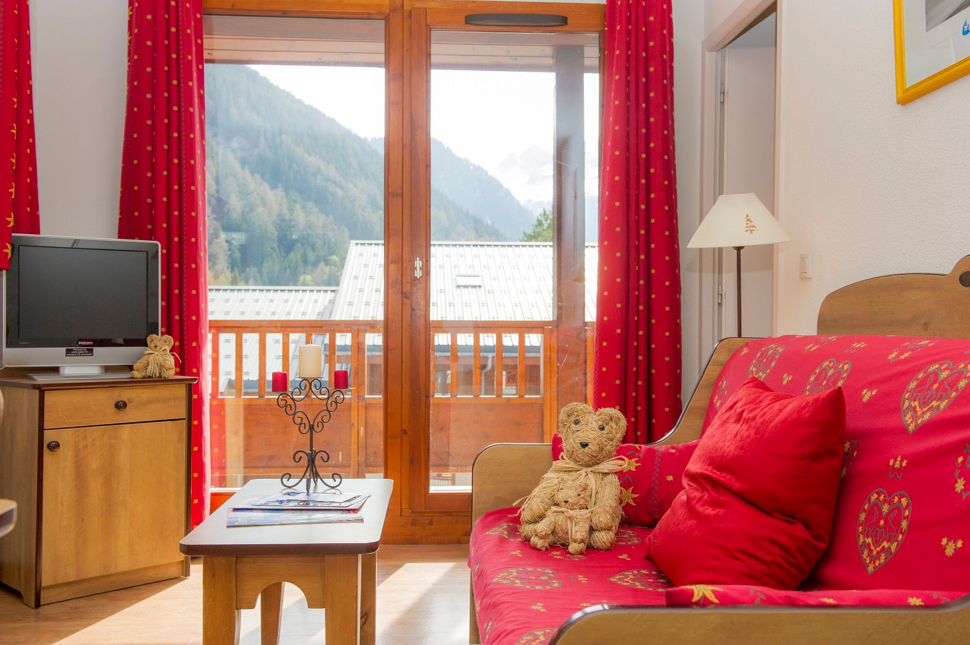 image Living room corner with a patterned sofa bed and balcony doors