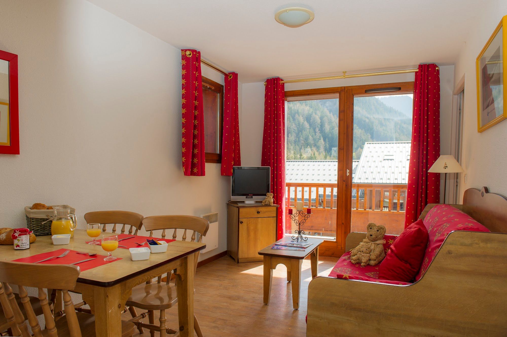 image Living and dining room with breakfast laid on the table.