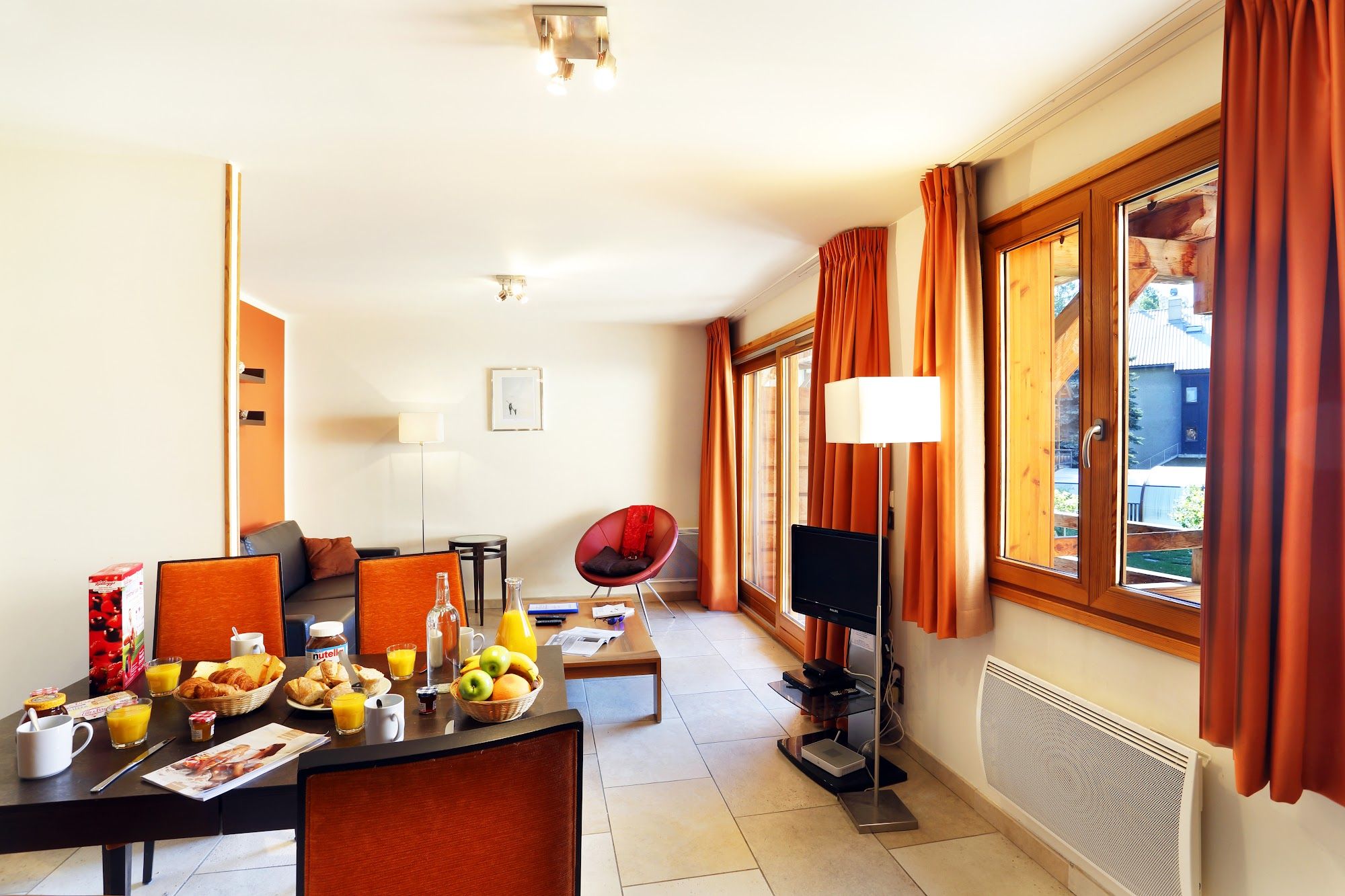 image Balcony access invites a breath of mountain air right from the sofa.
