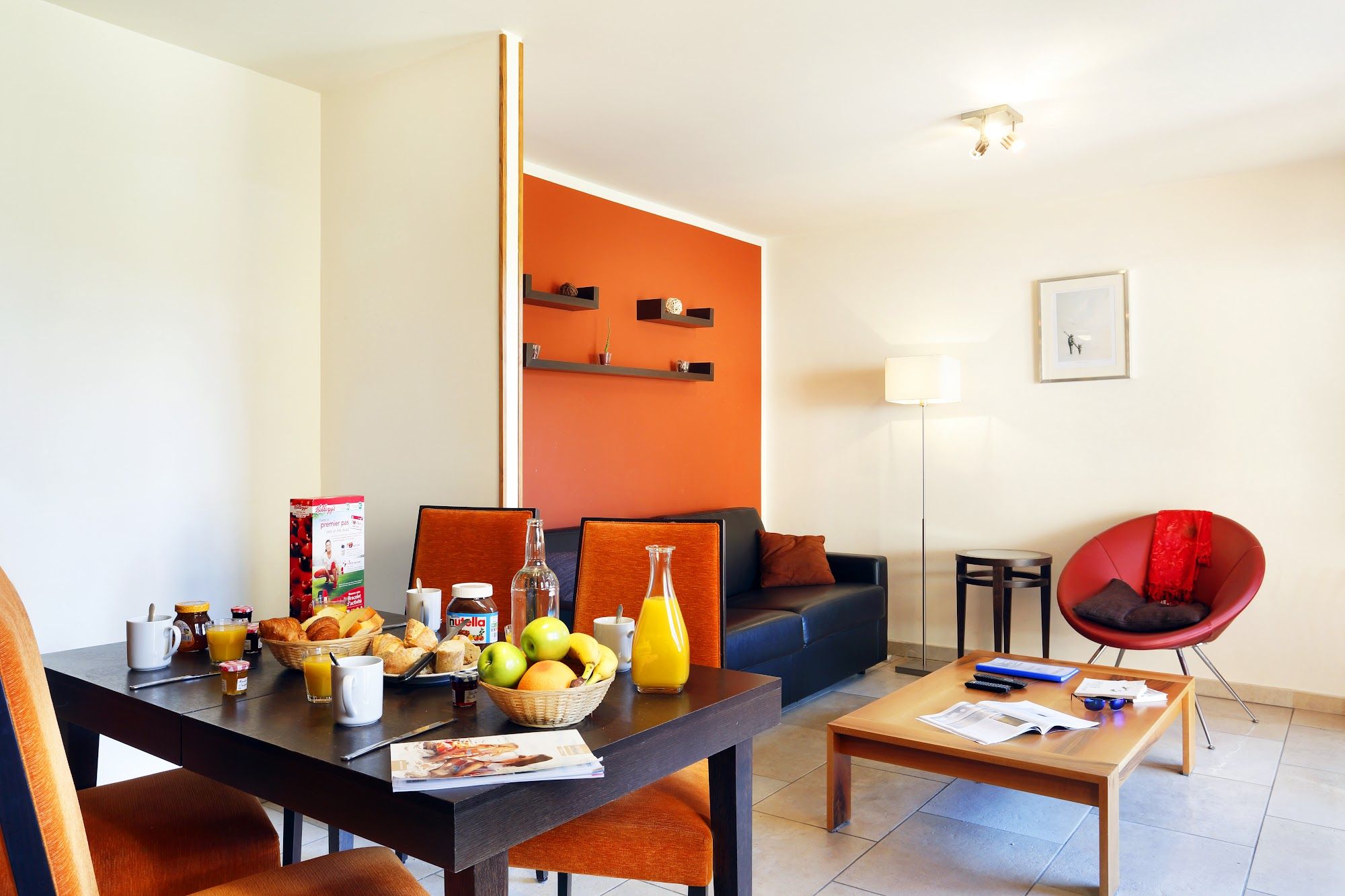 image An orange accent wall adds warmth to evenings in after a day on the pistes.