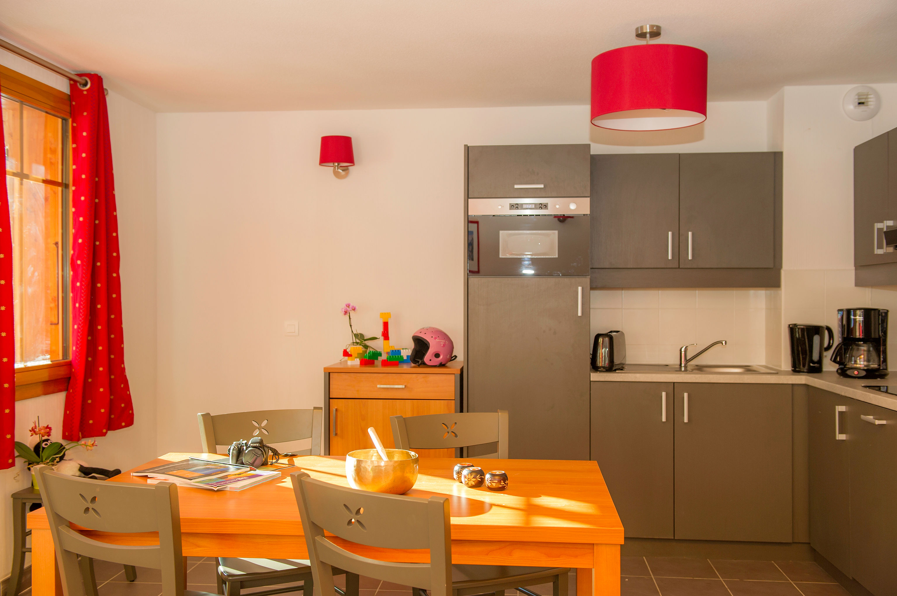 image Modern cabinetry lines the kitchen beside the dining table.