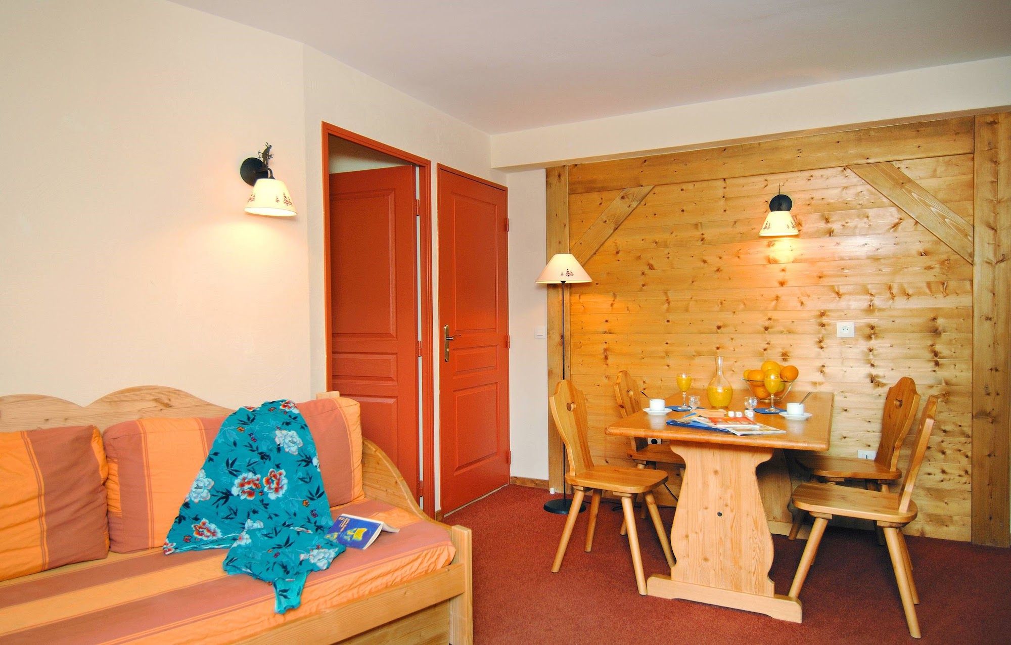 image Seating area with a table and doorways in the background.