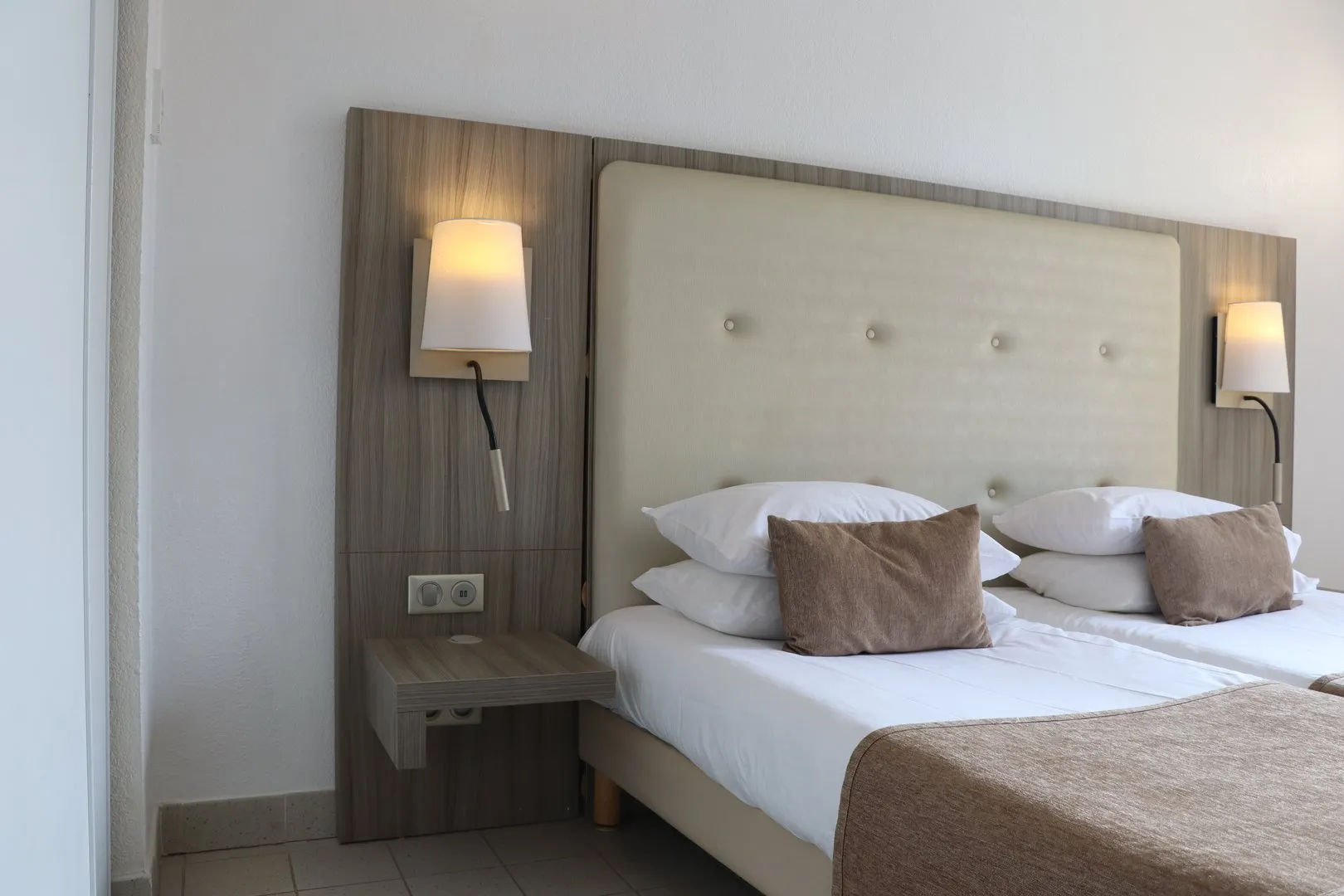 image Guest room with two beds and nightstand.