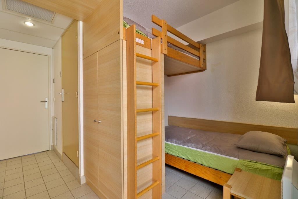 image Bedroom with a bunk bed and single bed.