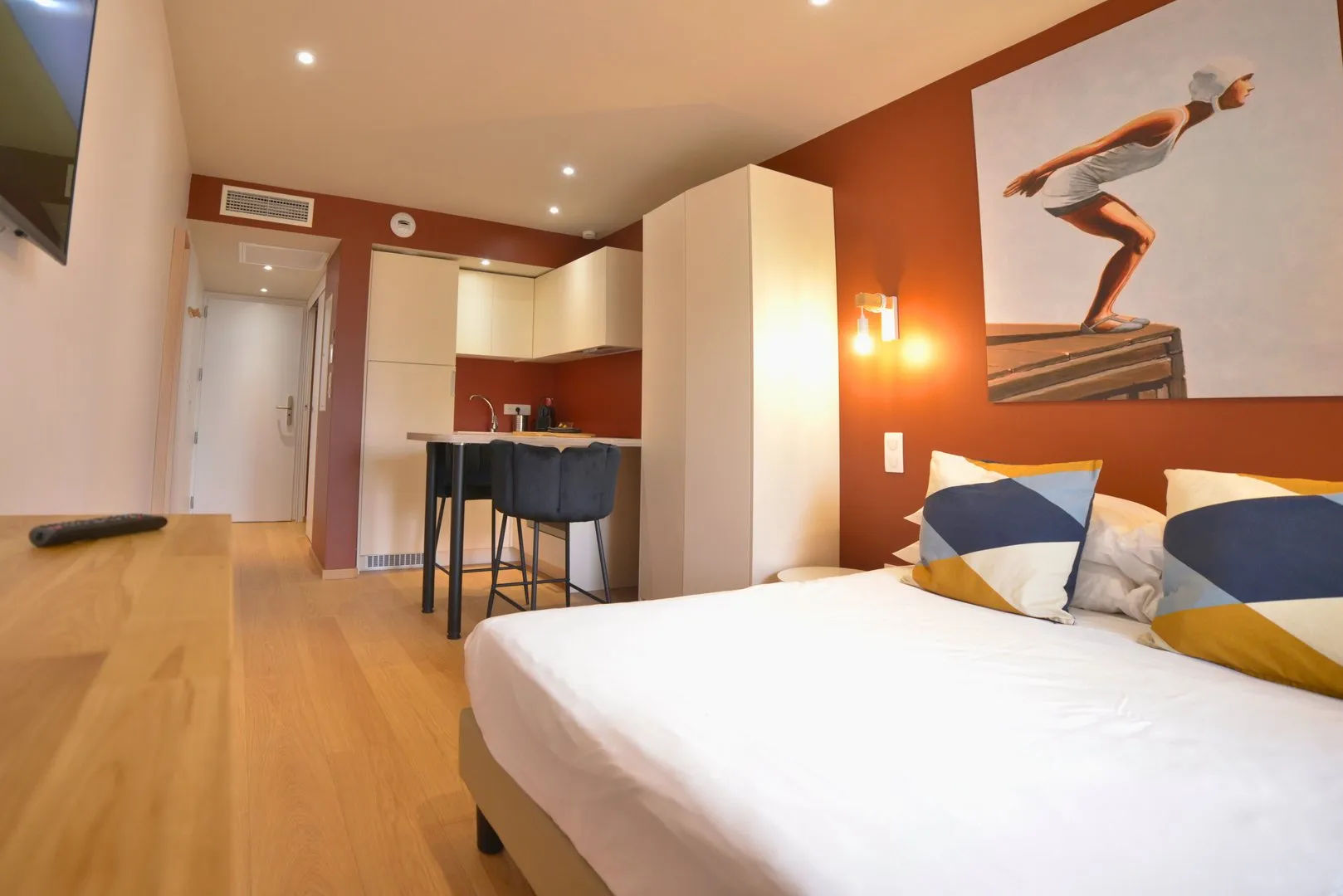 image Studio with bed, artwork, and kitchenette.