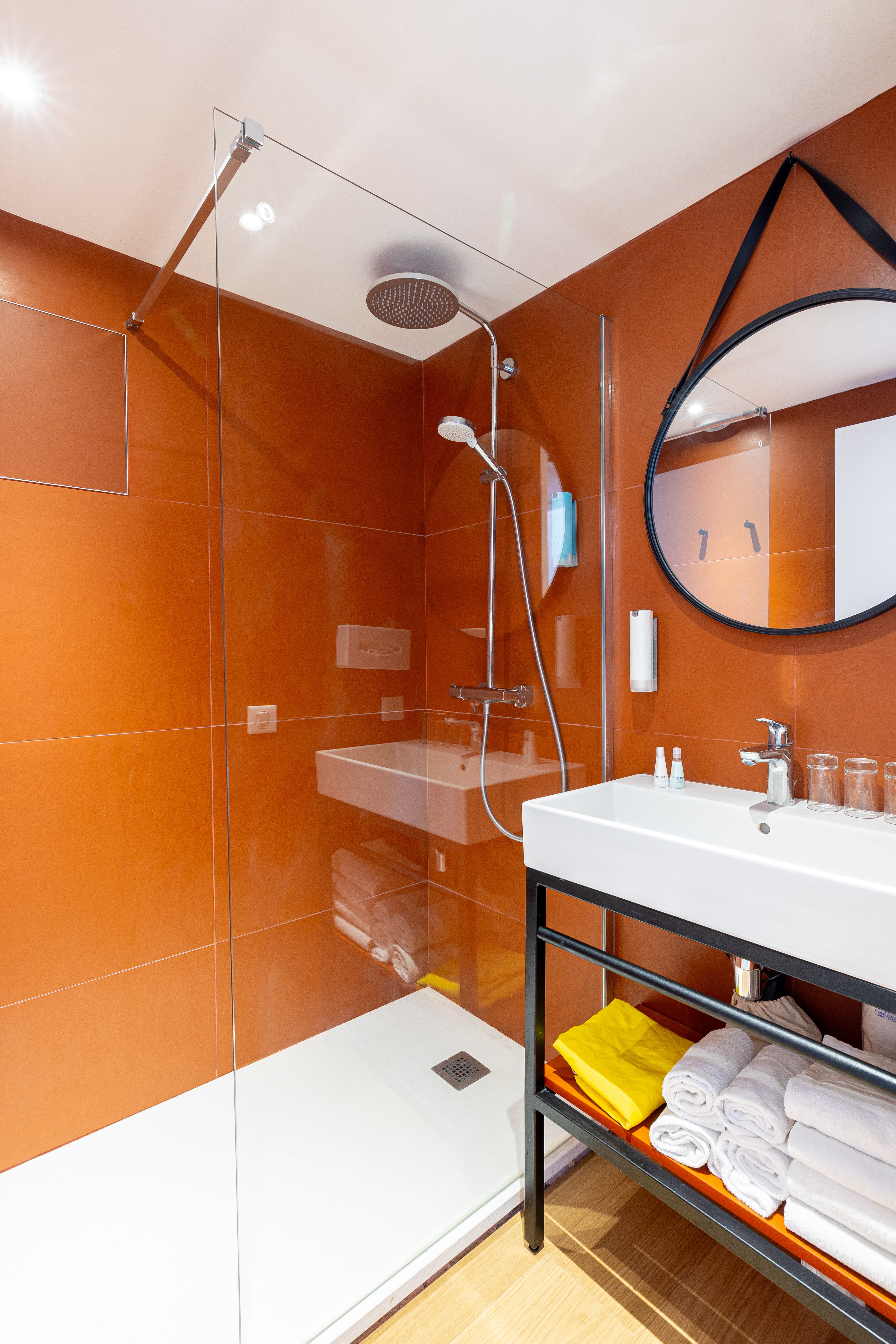 image Shower space with a glass enclosure and sink.