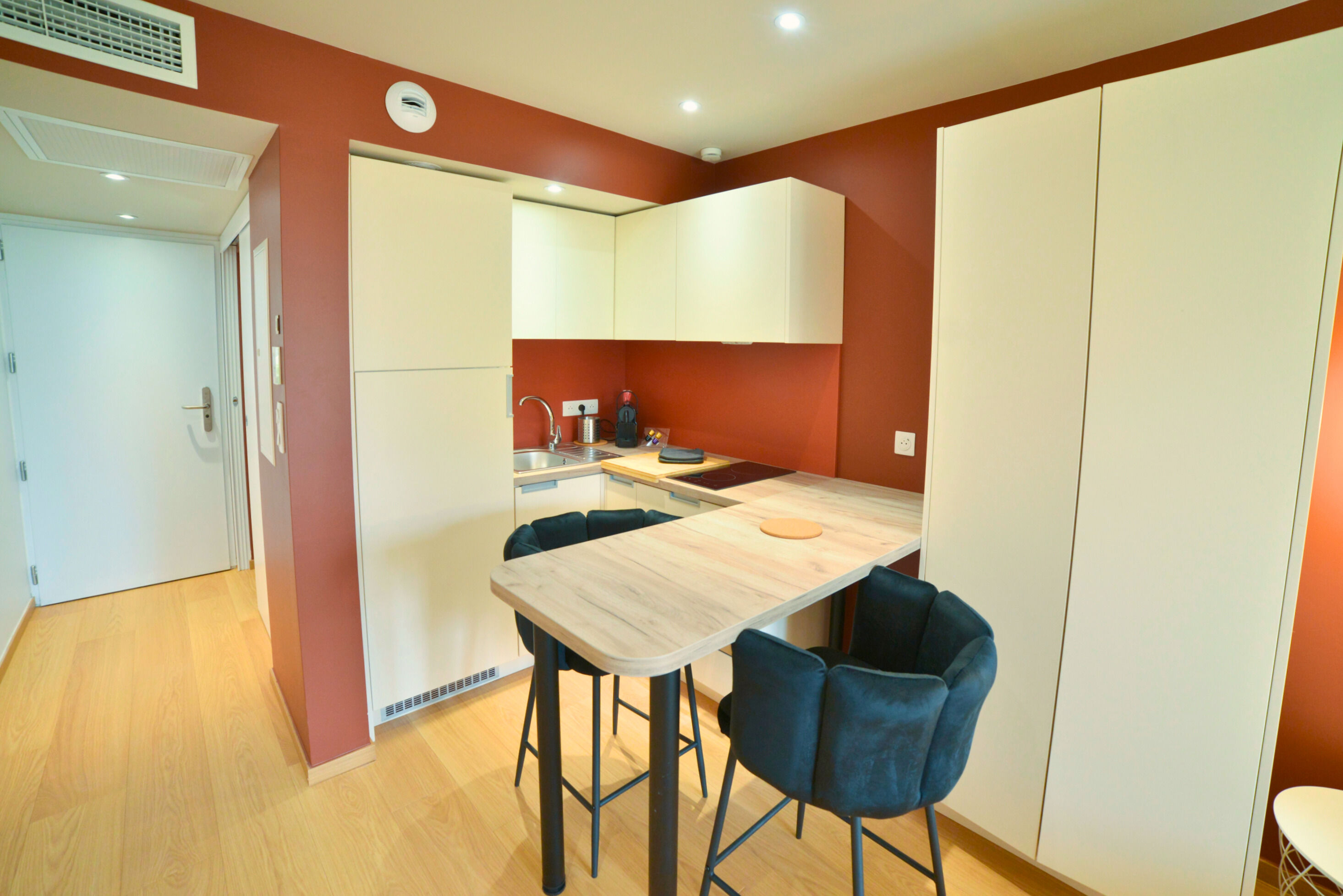 image Kitchenette with a countertop, sink, and storage cabinets.