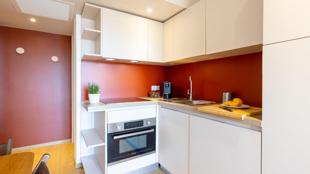 image Kitchen area with cabinets, sink, and small appliances.