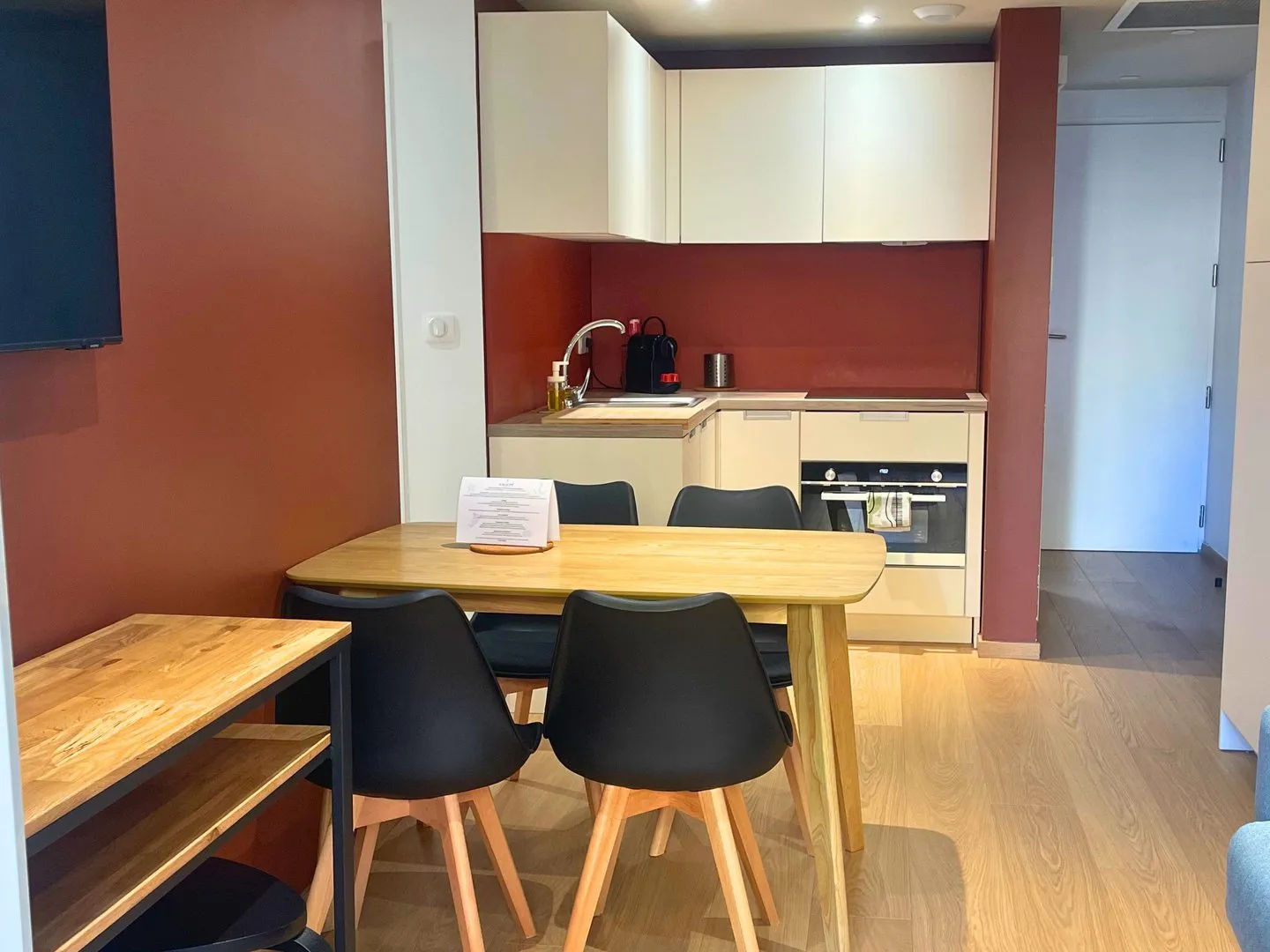 image Kitchen with dining table and modern appliances.