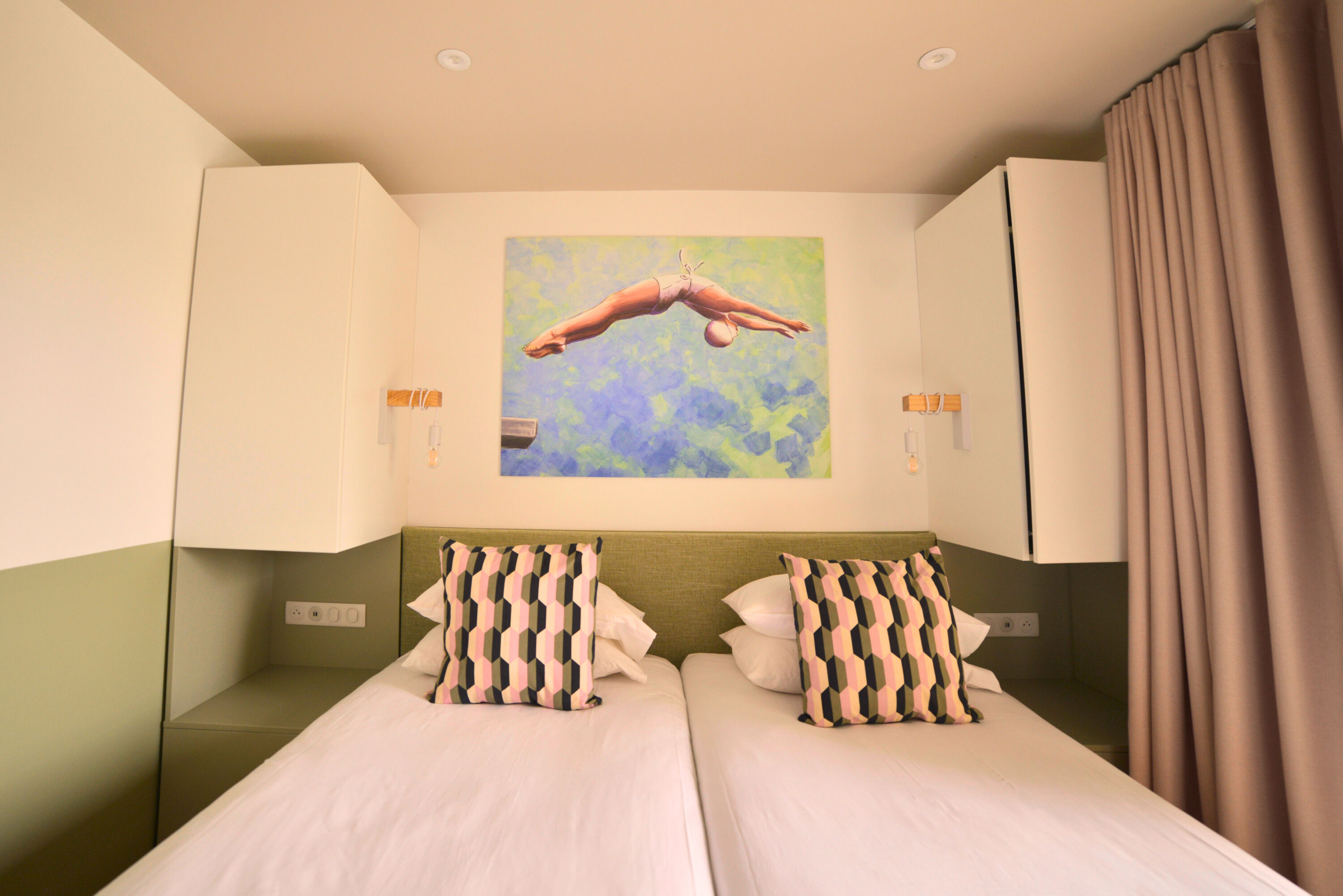 image Bedroom with two beds and patterned pillows.