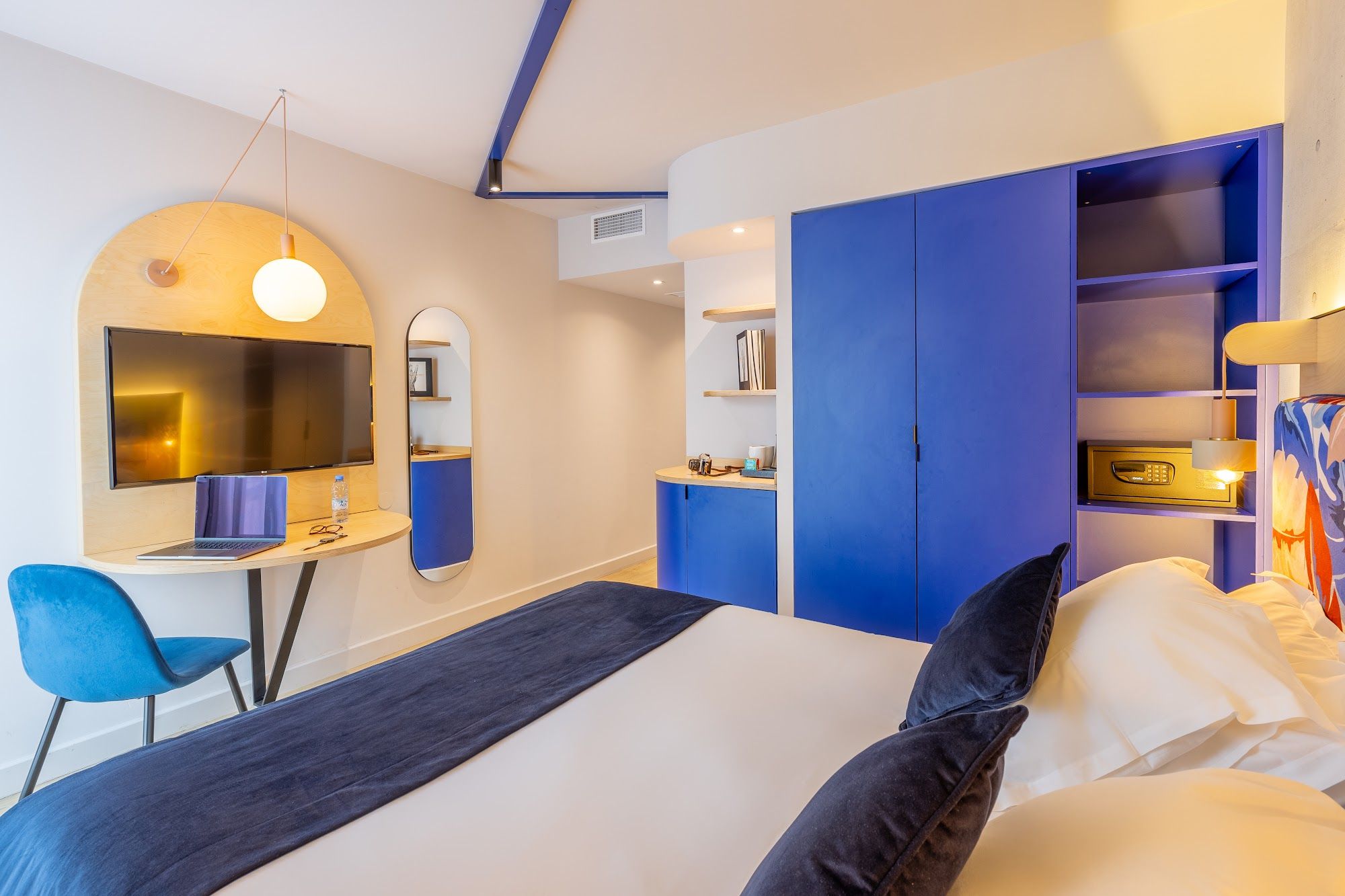 image Modern room with blue and cream decor, desk, and workspace