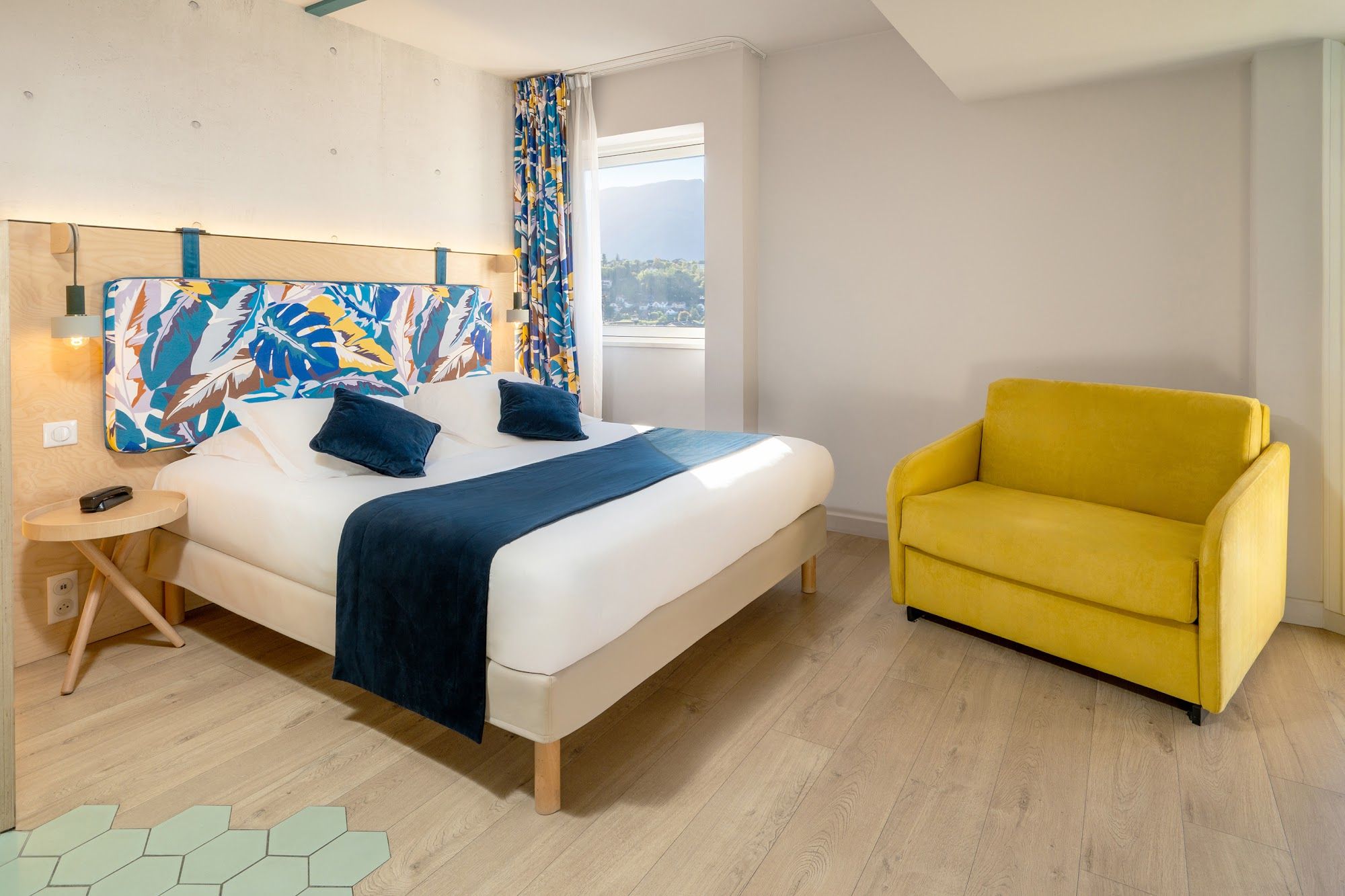 image Room with a double bed and yellow accent chair