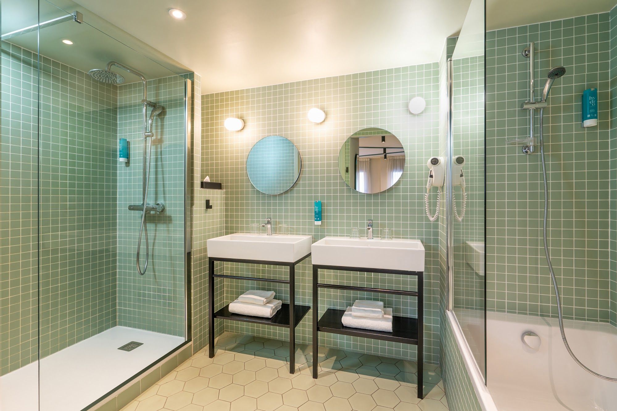 image Green tiled bathroom with double sinks and walk-in shower