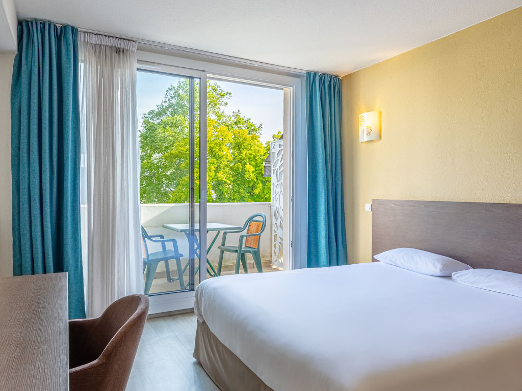 image Bright bedroom with large windows and balcony access.